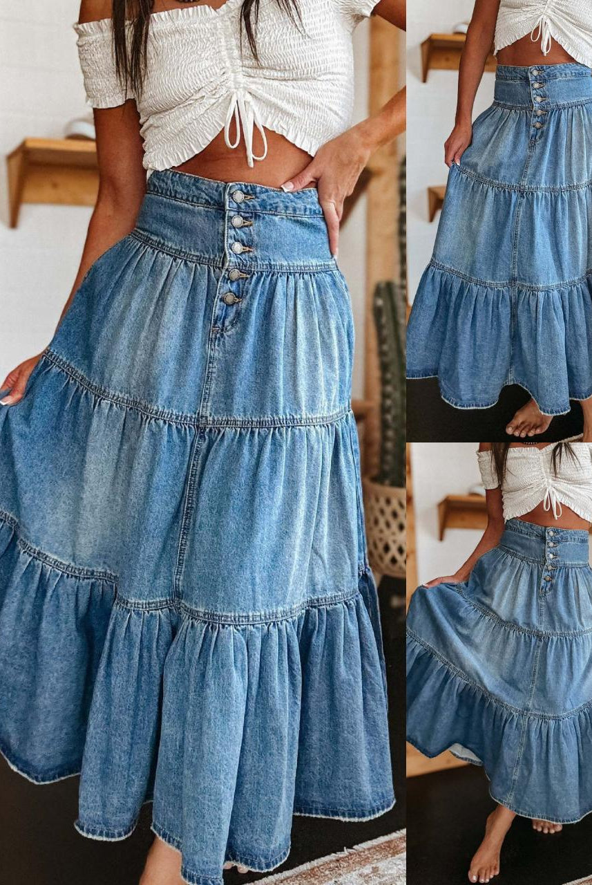 Woman in high-waisted tiered indigo cotton denim maxi skirt with button front - Bohemian Love Runway.
