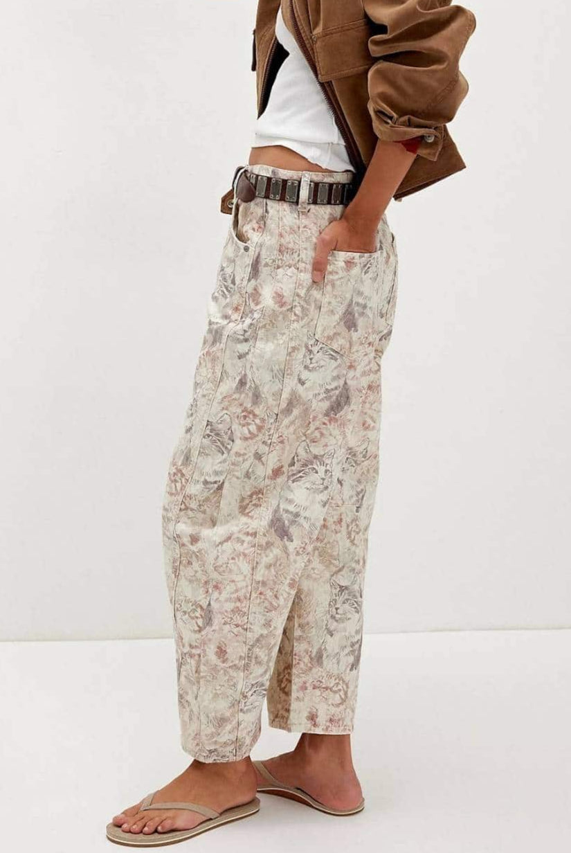 Woman wearing midi-rise artistic floral print barrel jeans in blush and taupe tones - relaxed boho cotton denim Australia.