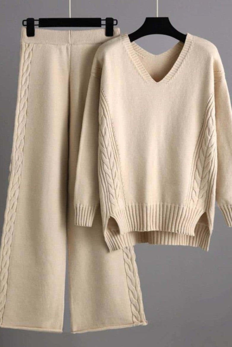 Woman wearing beige cotton cable knit lounge set with relaxed V-neck sweater and wide-leg pants - cozy boho loungewear Australia.