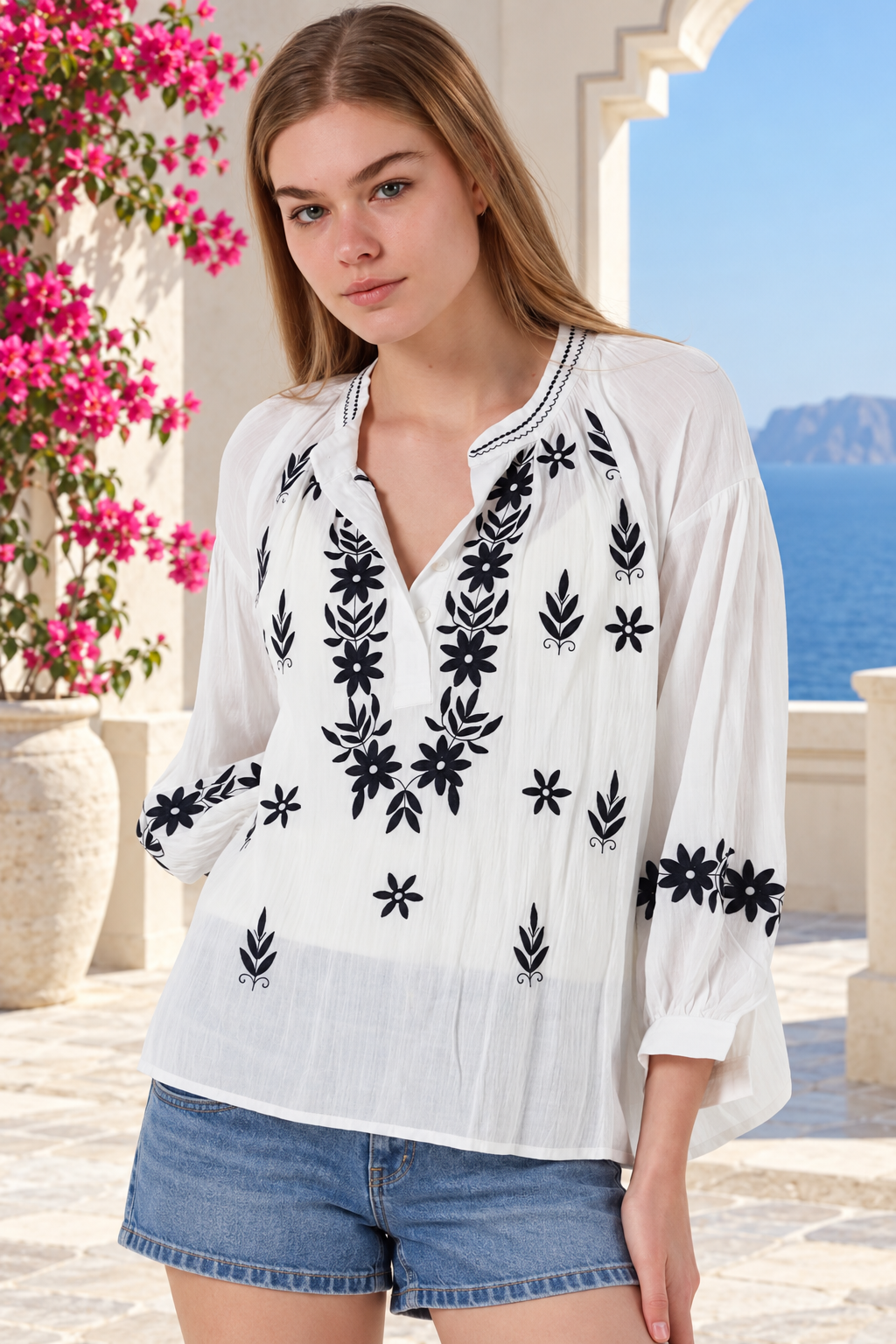 White Salty Palm cotton blouse with navy floral embroidery, V-neck button front, gathered long sleeves and stitched cuffs
