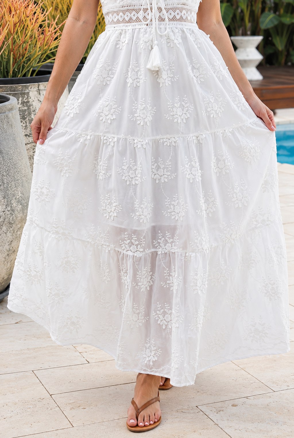 Olivia white embroidered cotton maxi dress with lace waist, tassel V-neck, adjustable straps and tiered skirt