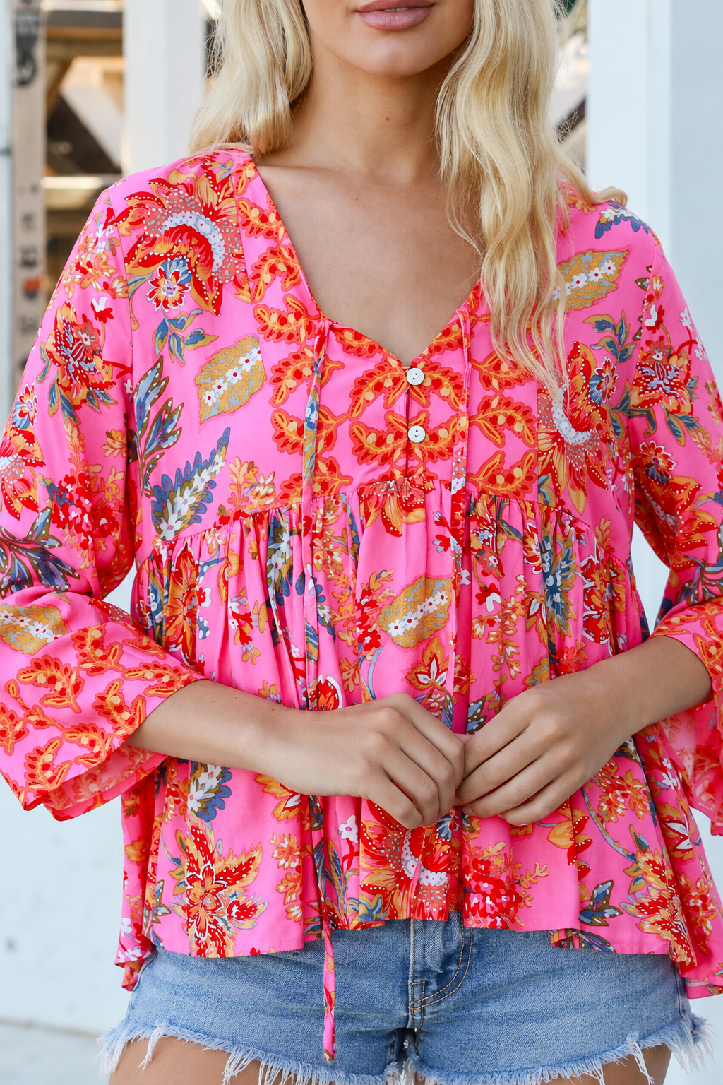 Sintra pink floral boho top with V-neck, button front, ties and three-quarter bell sleeves