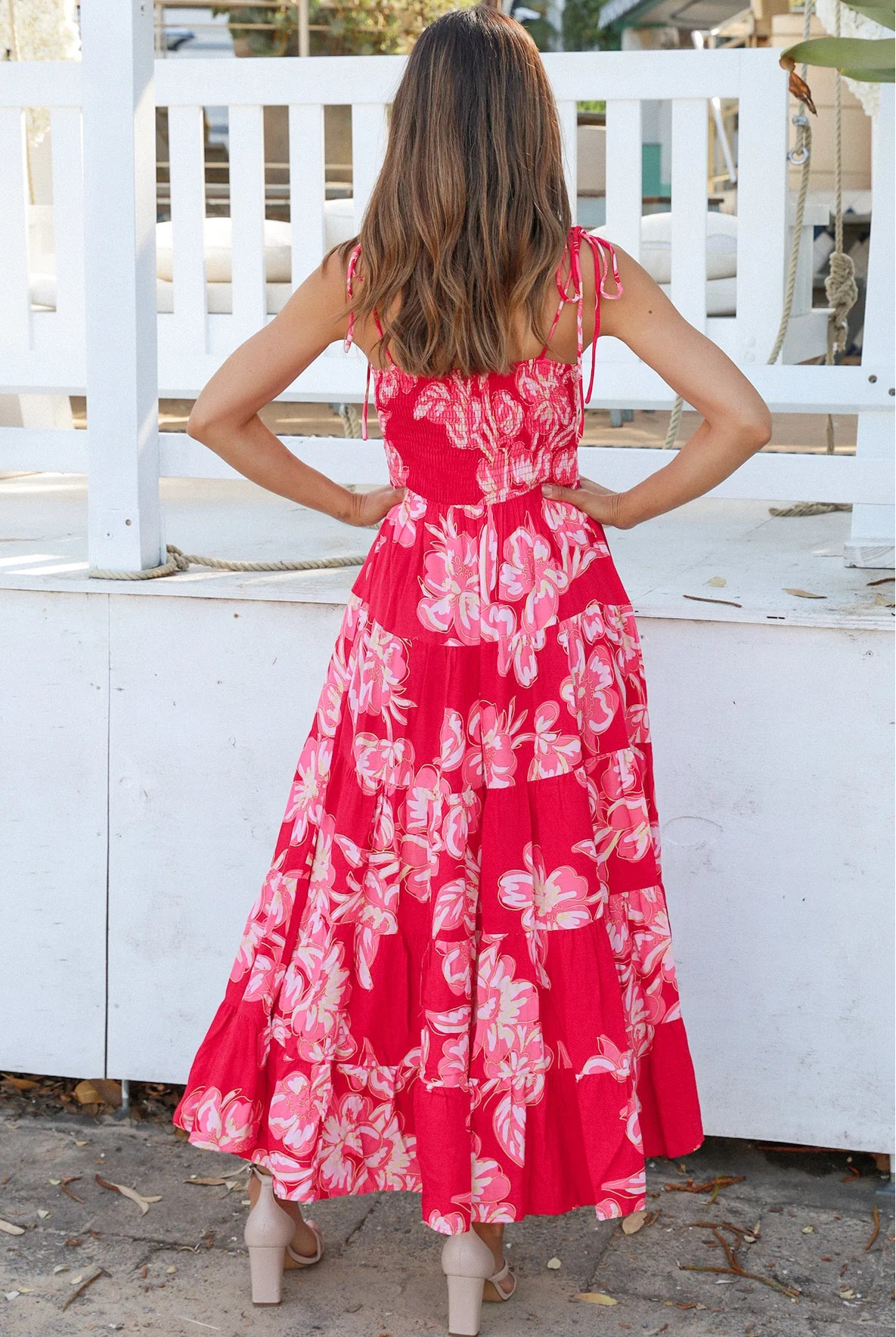 Woman wearing the Zaria Rose Maxi red floral boho maxi dress with tie straps - romantic summer fashion Australia.
