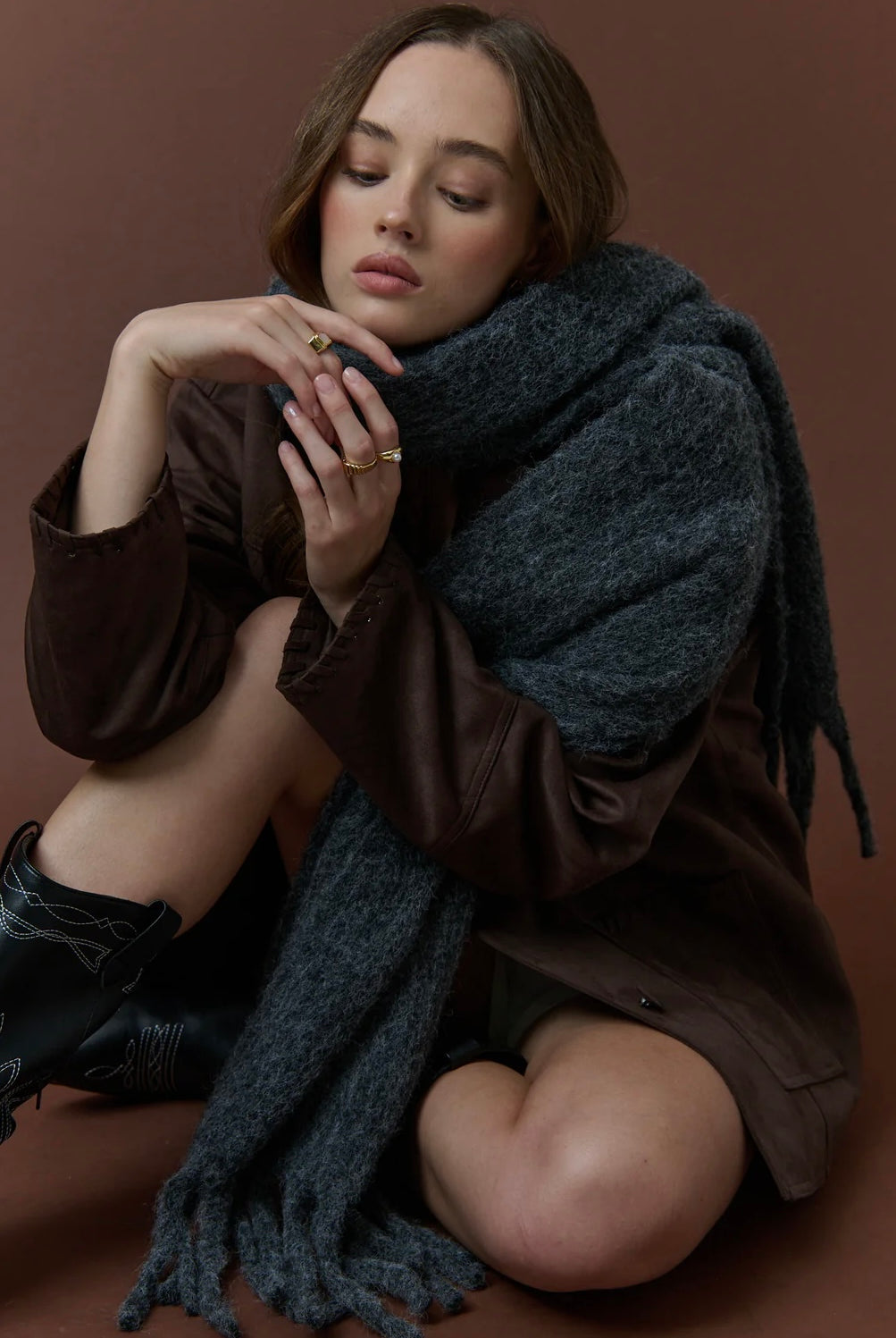 Woman wrapped in a charcoal fluffy boho wool blend scarf with fringe - The Midnight Hour winter wrap from Bohemian Love Runway.