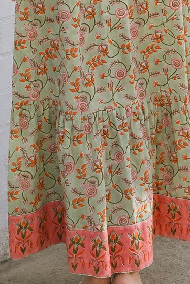 Lauren 100% cotton floral boho maxi dress in sage green with coral botanical print, tassel ties and contrast border hem