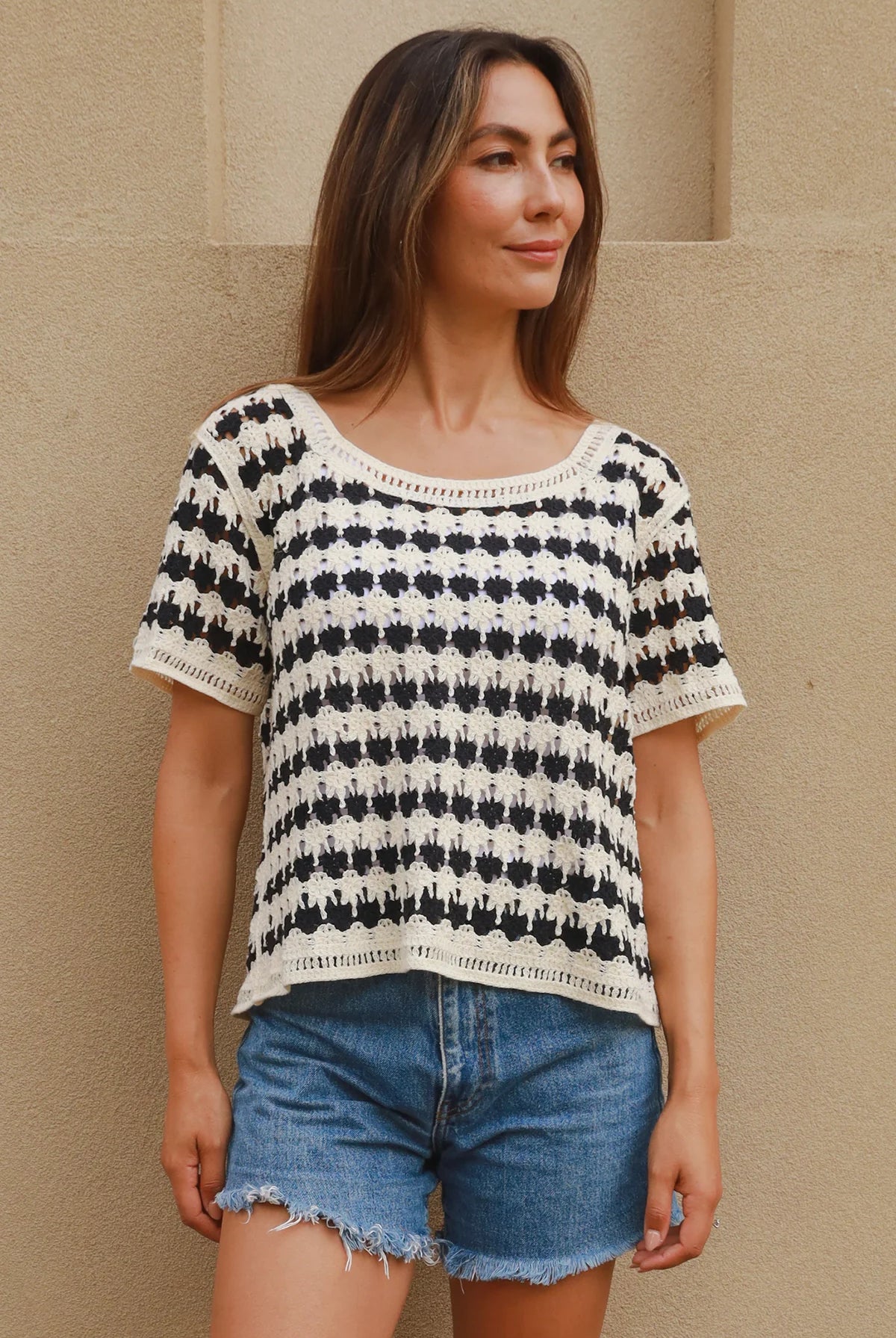 Woman wearing black and cream crochet cotton top with checkerboards pattern - boho summer fashion Australia.