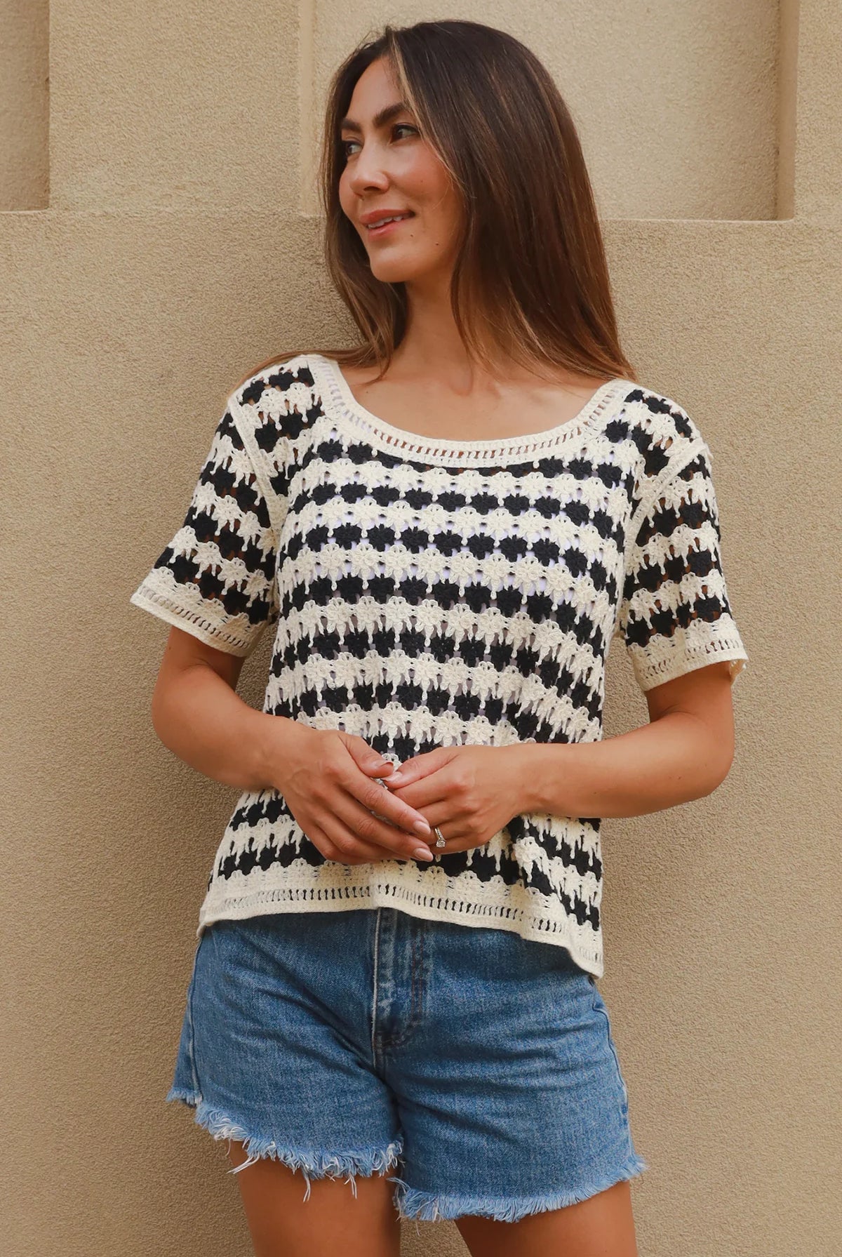 Woman wearing black and cream crochet cotton top with checkerboards pattern - boho summer fashion Australia.