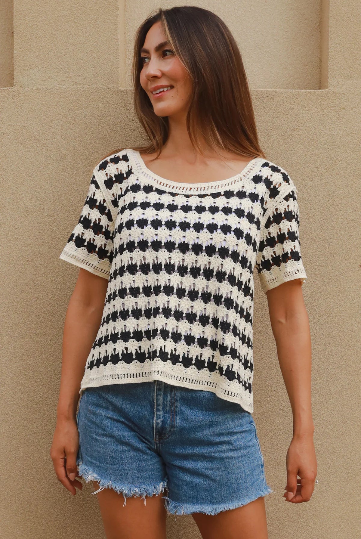 Woman wearing black and cream crochet cotton top with checkerboards pattern - boho summer fashion Australia.