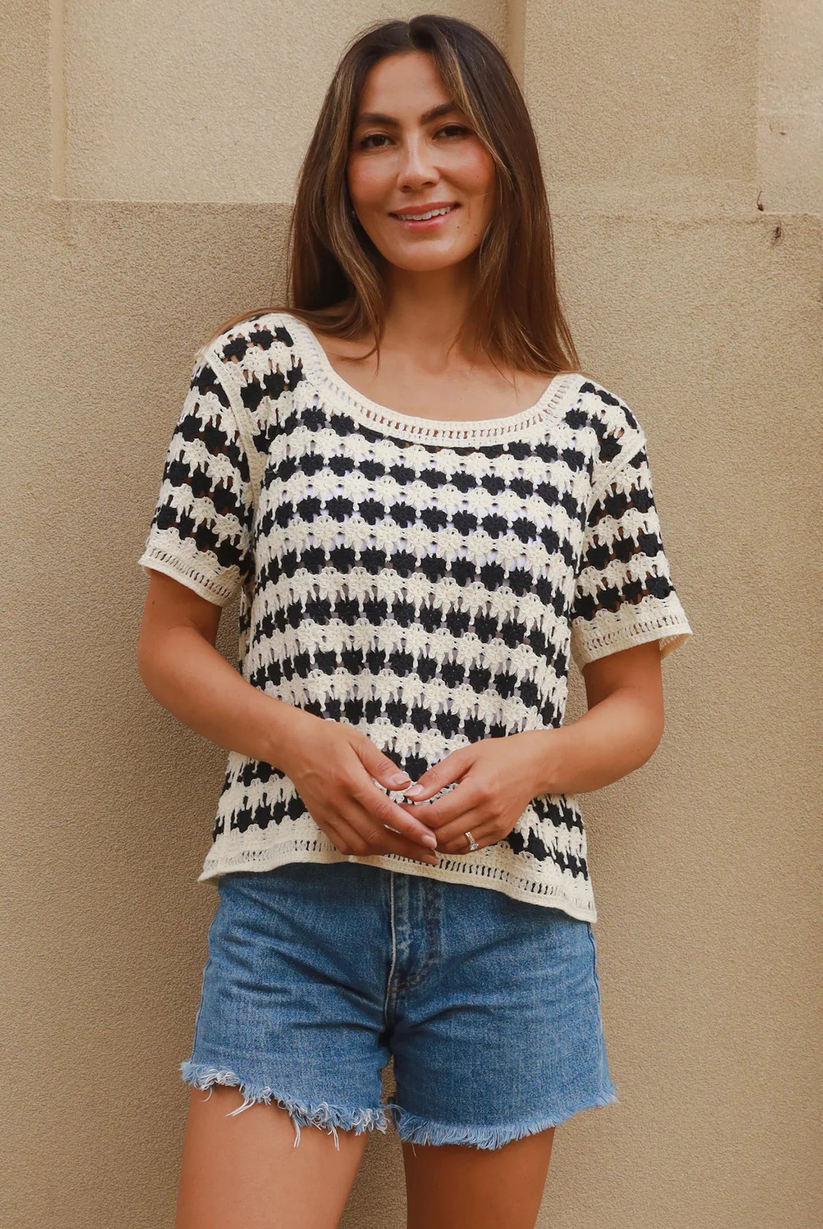 Woman wearing black and cream crochet cotton top with checkerboards pattern - boho summer fashion Australia.