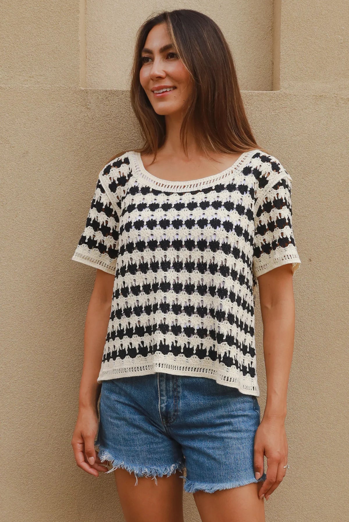 Woman wearing black and cream crochet cotton top with checkerboards pattern - boho summer fashion Australia.