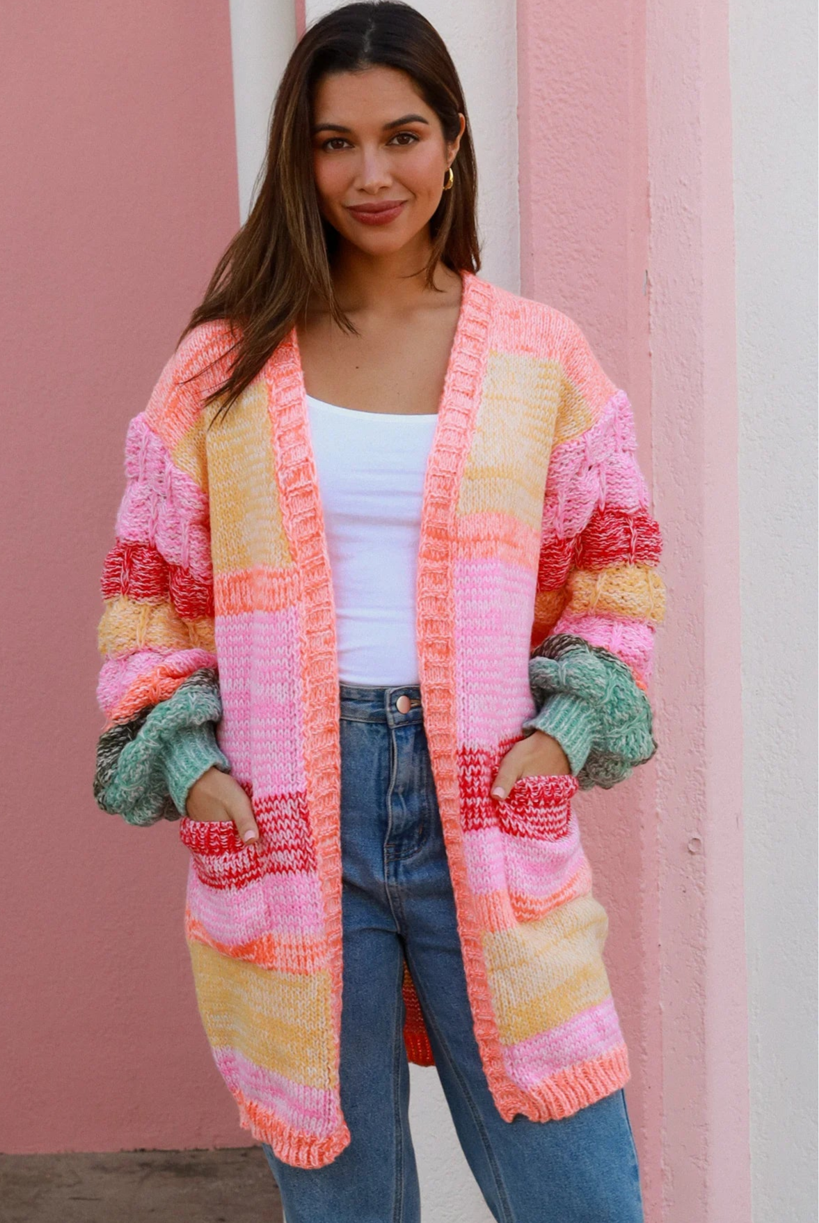 Woman in a colourful chunky knit Boho cardigan with stripes and oversized sleeves - boho knitwear Australia.