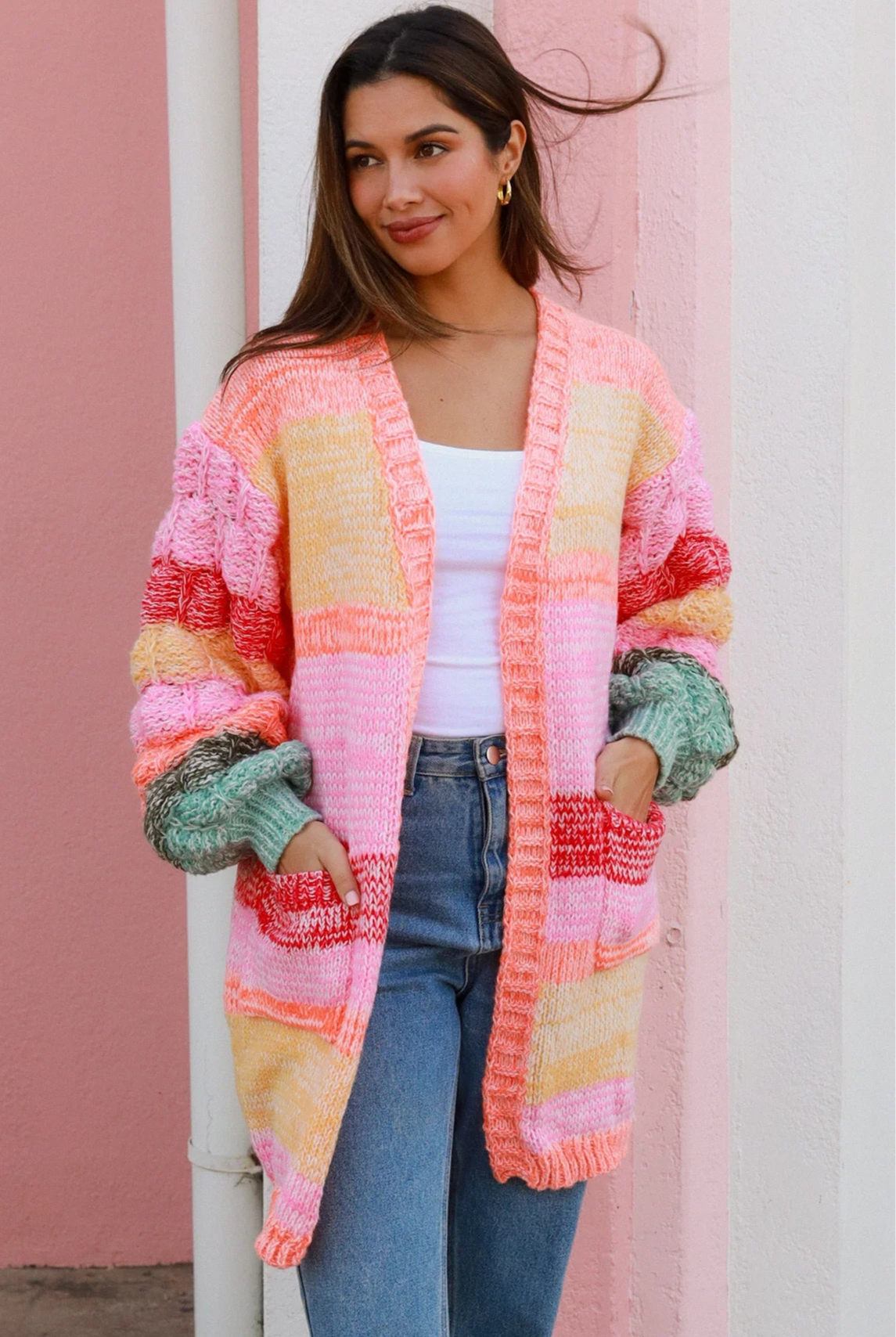 Woman in a colourful chunky knit Boho cardigan with stripes and oversized sleeves - boho knitwear Australia.