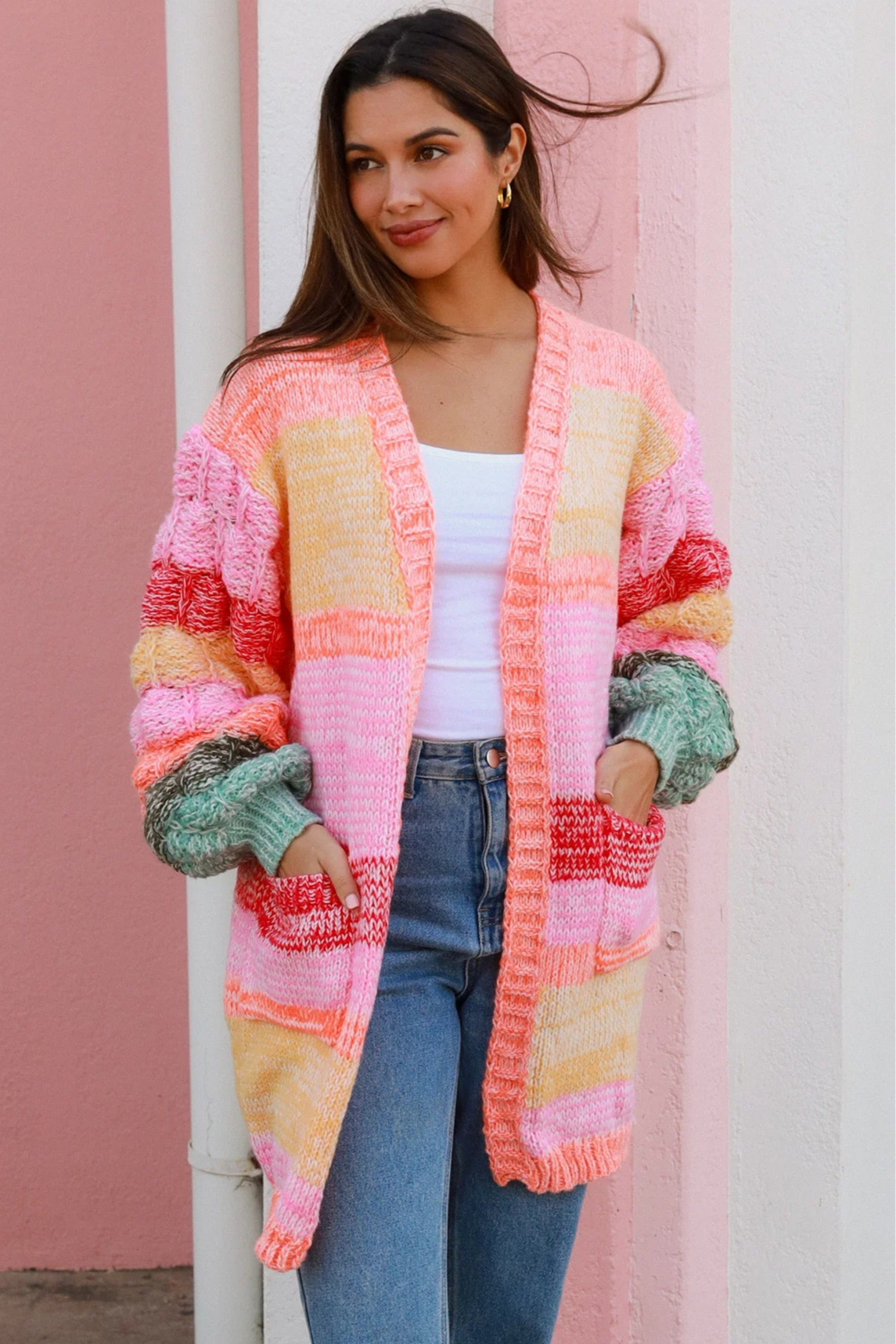 Woman in a colourful chunky knit Boho cardigan with stripes and oversized sleeves - boho knitwear Australia.