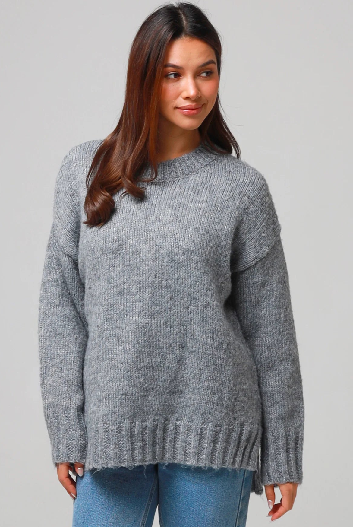 Woman wearing a grey wool blend knit jumper with ribbed cuffs and hem- boho winter jumper Australia.