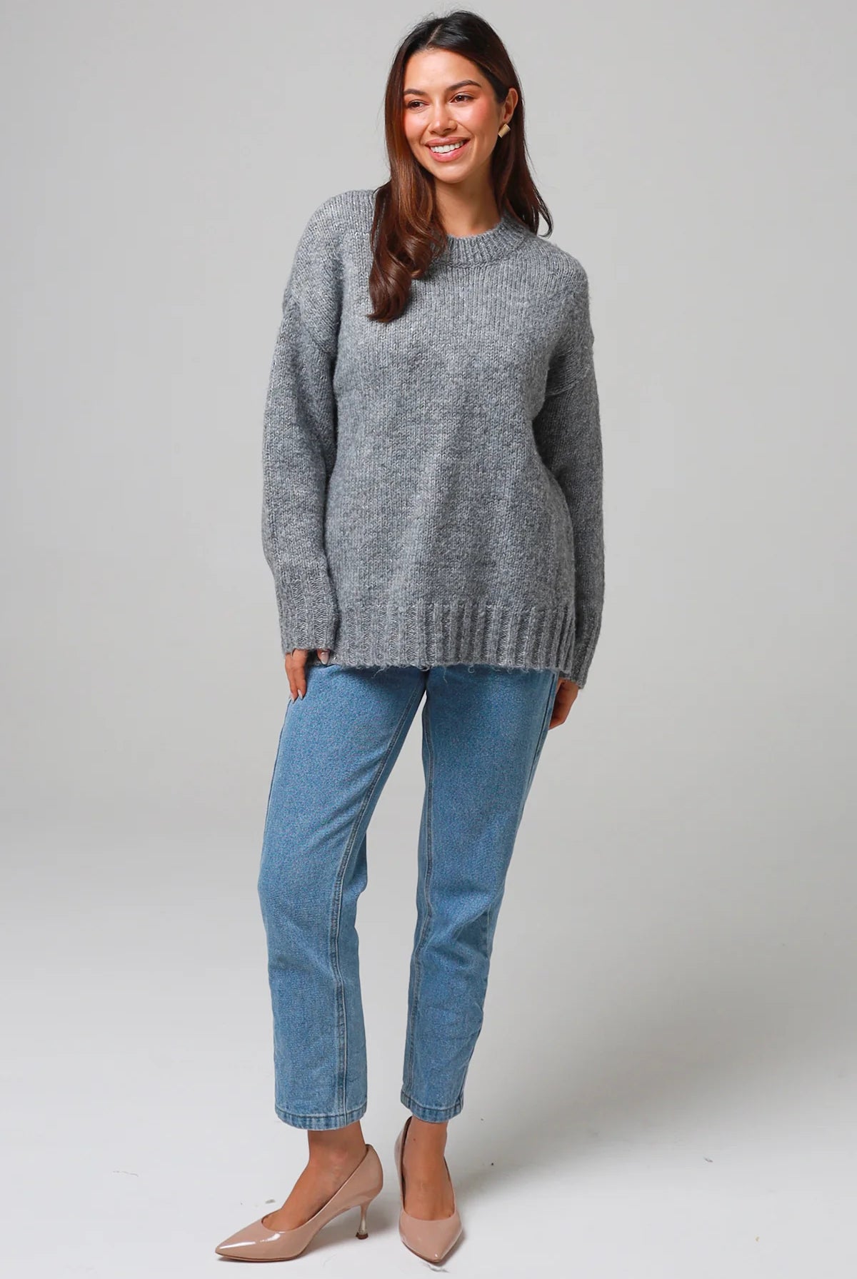 Woman wearing a grey wool blend knit jumper with ribbed cuffs and hem- boho winter jumper Australia.