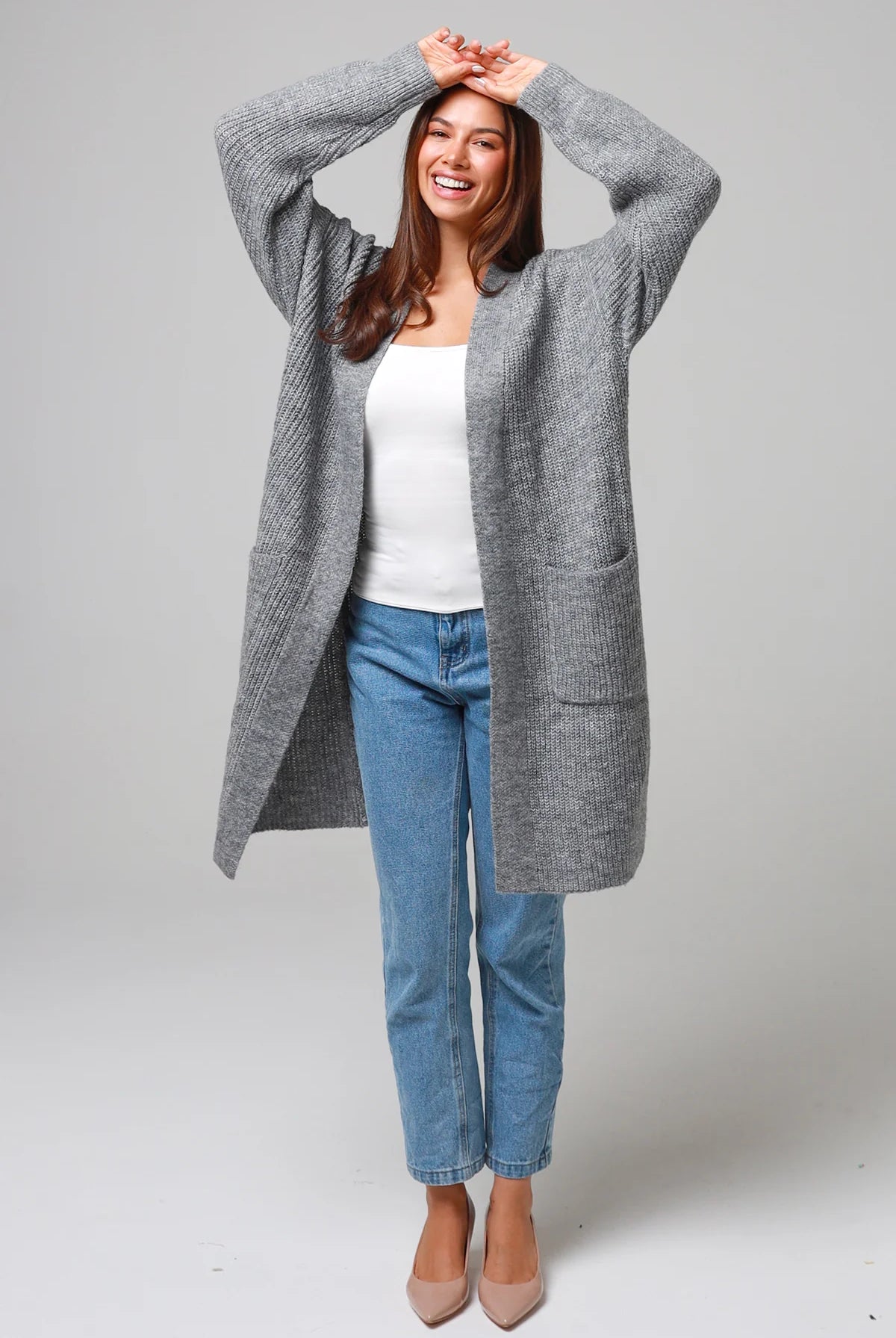 Women wearing a grey longline knit cardigan with pockets and jeans - soft boho wool blend knitwear Australia.
