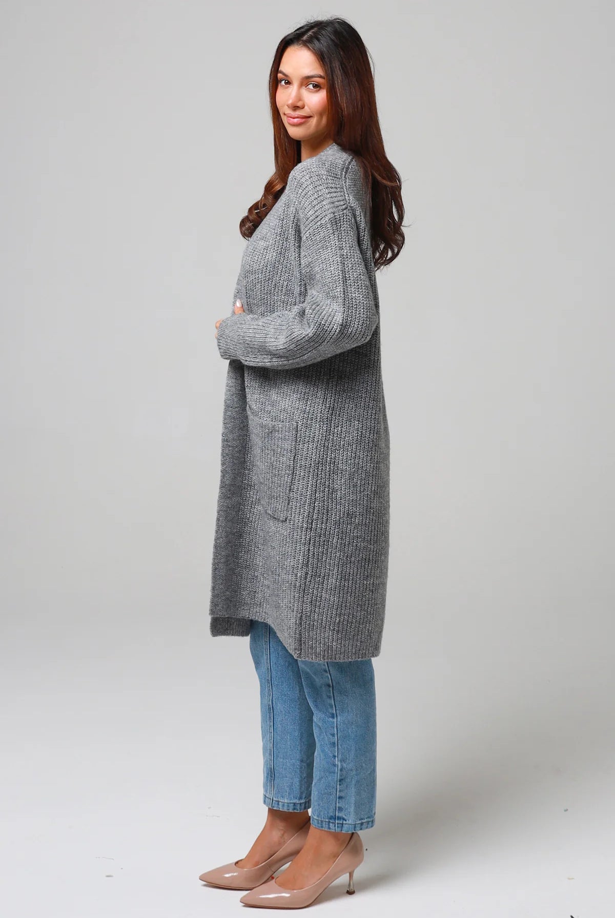 Women wearing a grey longline knit cardigan with pockets and jeans - soft boho wool blend knitwear Australia.