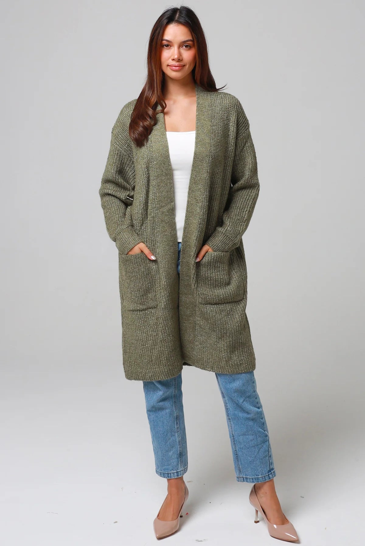 Woman in Khaki longline cardigan with patch pockets and denim - earthy boho wool blend knitwear Australia.