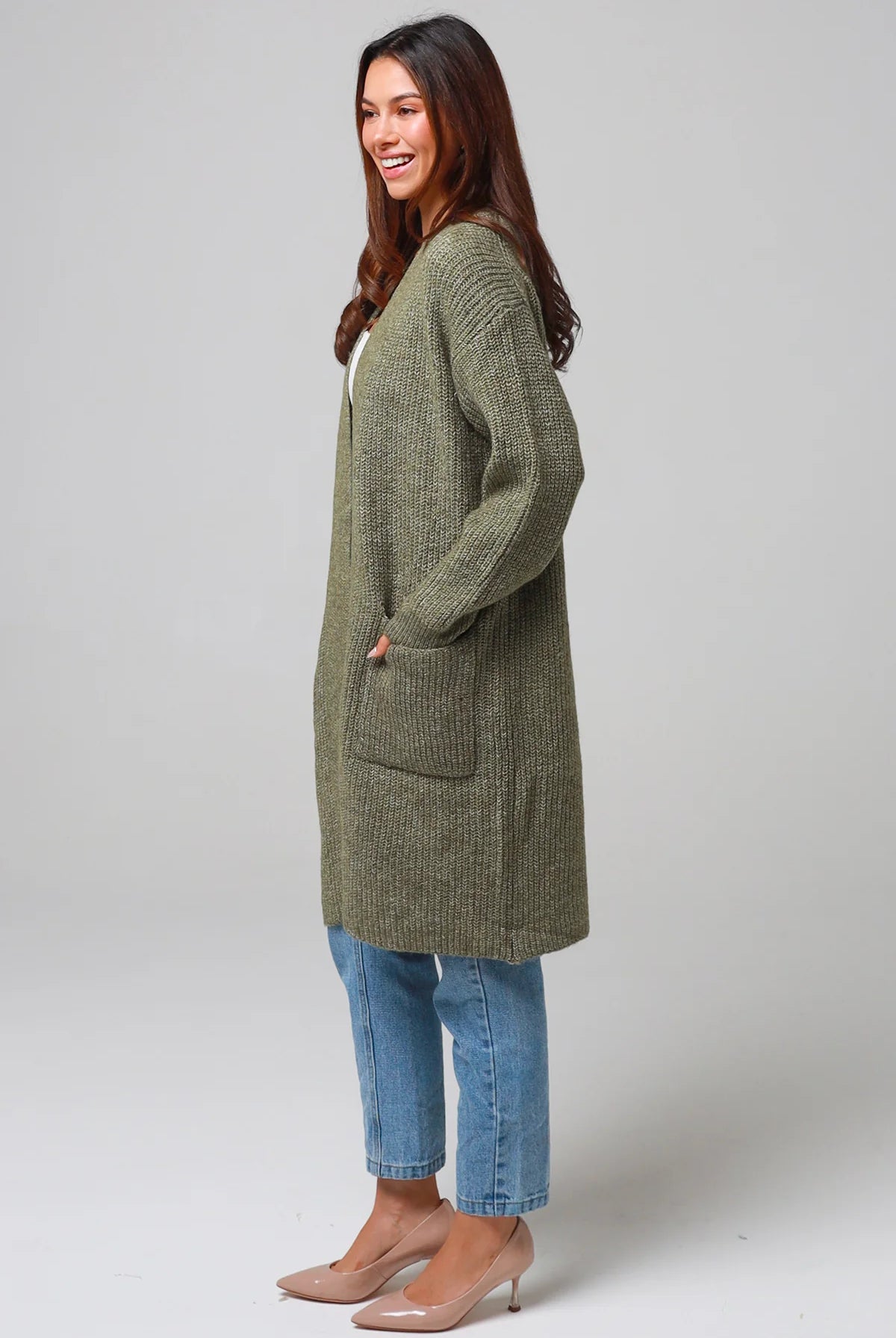 Woman in Khaki longline cardigan with patch pockets and denim - earthy boho wool blend knitwear Australia.