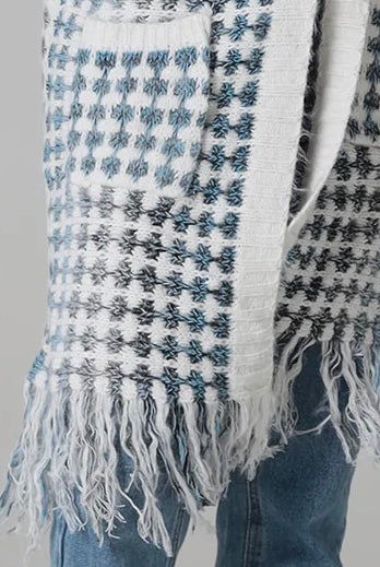Woman wearing Juliet white and blue houndstooth longline fringe knit cardigan with drop shoulder sleeves, ribbed cuffs and front pockets by Charlotte The Label.