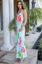 Woman wearing aqua floral v-neck maxi dress with pink and coral blooms – Charlotte the Label boho dresses Australia