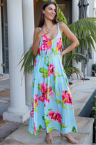 Woman wearing aqua floral v-neck maxi dress with pink and coral blooms – Charlotte the Label boho dresses Australia