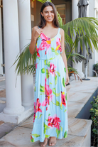 Woman wearing aqua floral v-neck maxi dress with pink and coral blooms – Charlotte the Label boho dresses Australia