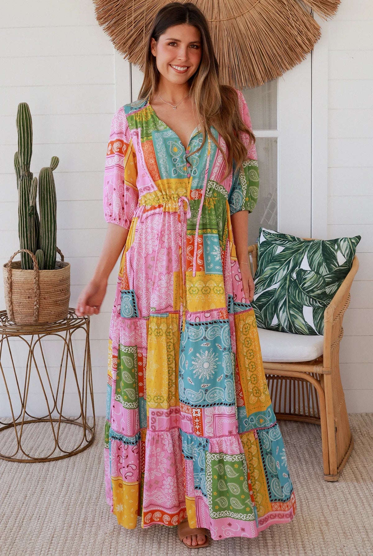 Woman in colourful patchwork paisley boho maxi dress with v-neck button bodice and tiered skirt - Boho Fashion Australia