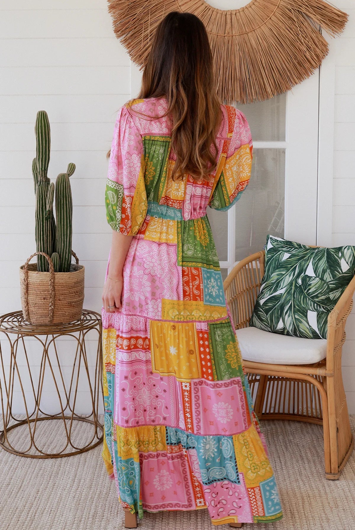 Woman in colourful patchwork paisley boho maxi dress with v-neck button bodice and tiered skirt - Boho Fashion Australia