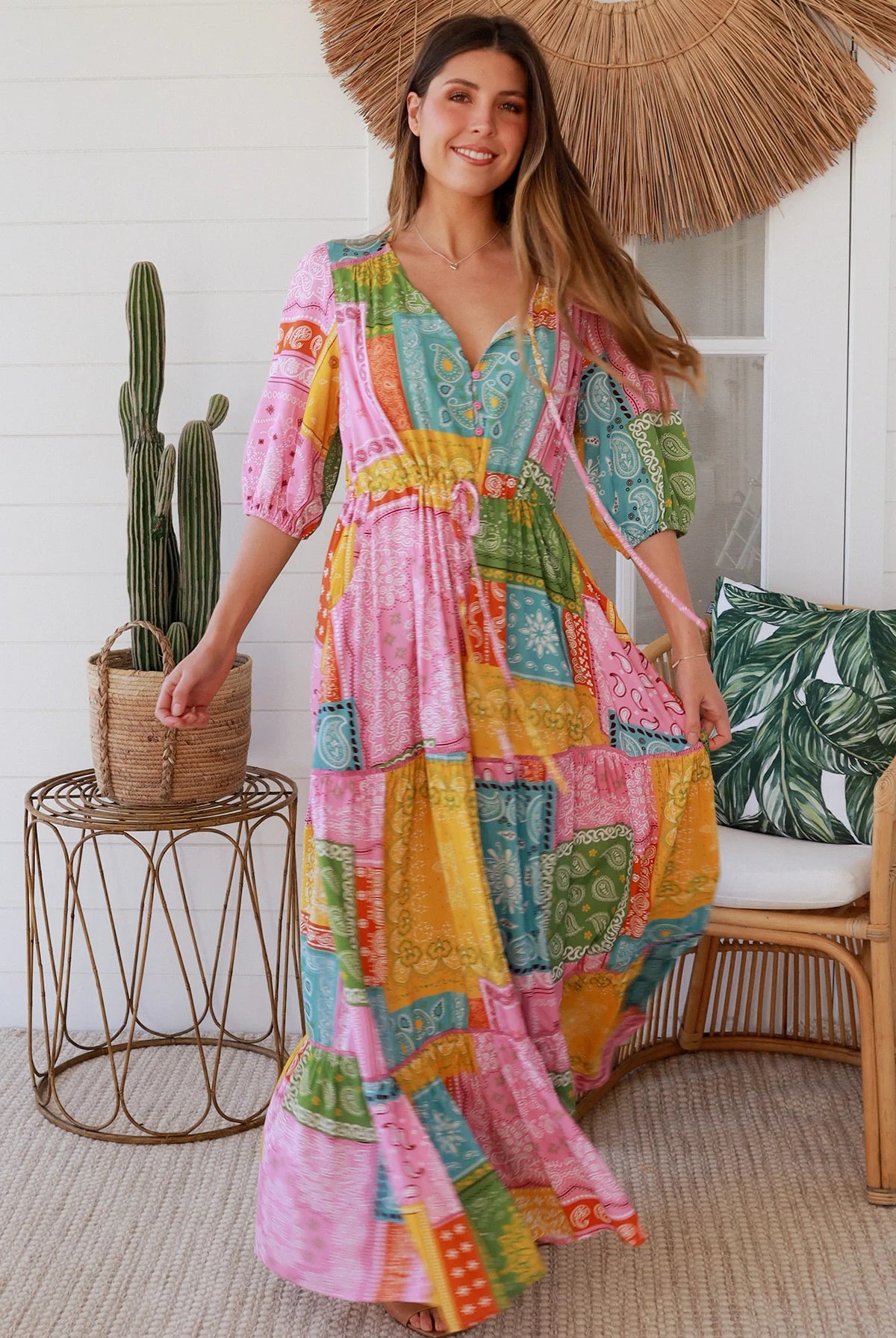 Woman in colourful patchwork paisley boho maxi dress with v-neck button bodice and tiered skirt - Boho Fashion Australia