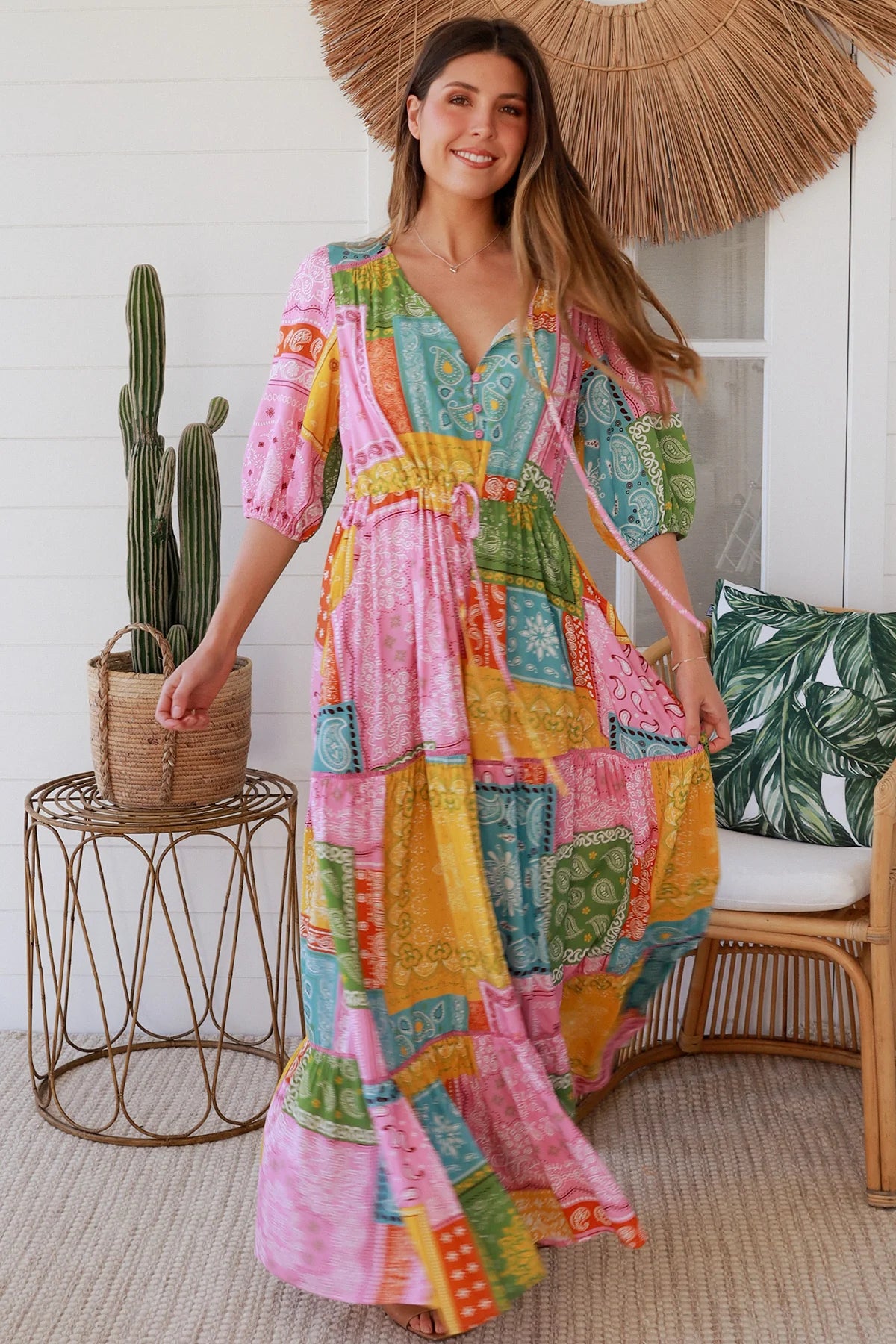 Woman in colourful patchwork paisley boho maxi dress with v-neck button bodice and tiered skirt - Boho Fashion Australia