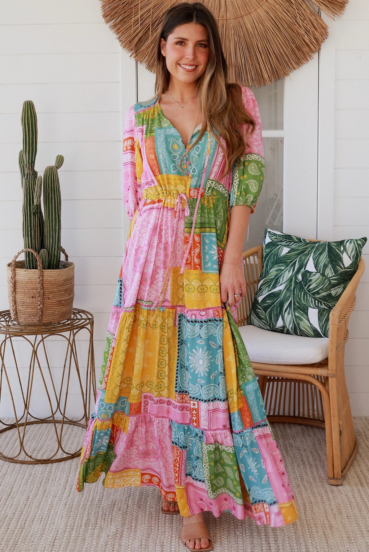 Woman in colourful patchwork paisley boho maxi dress with v-neck button bodice and tiered skirt - Boho Fashion Australia