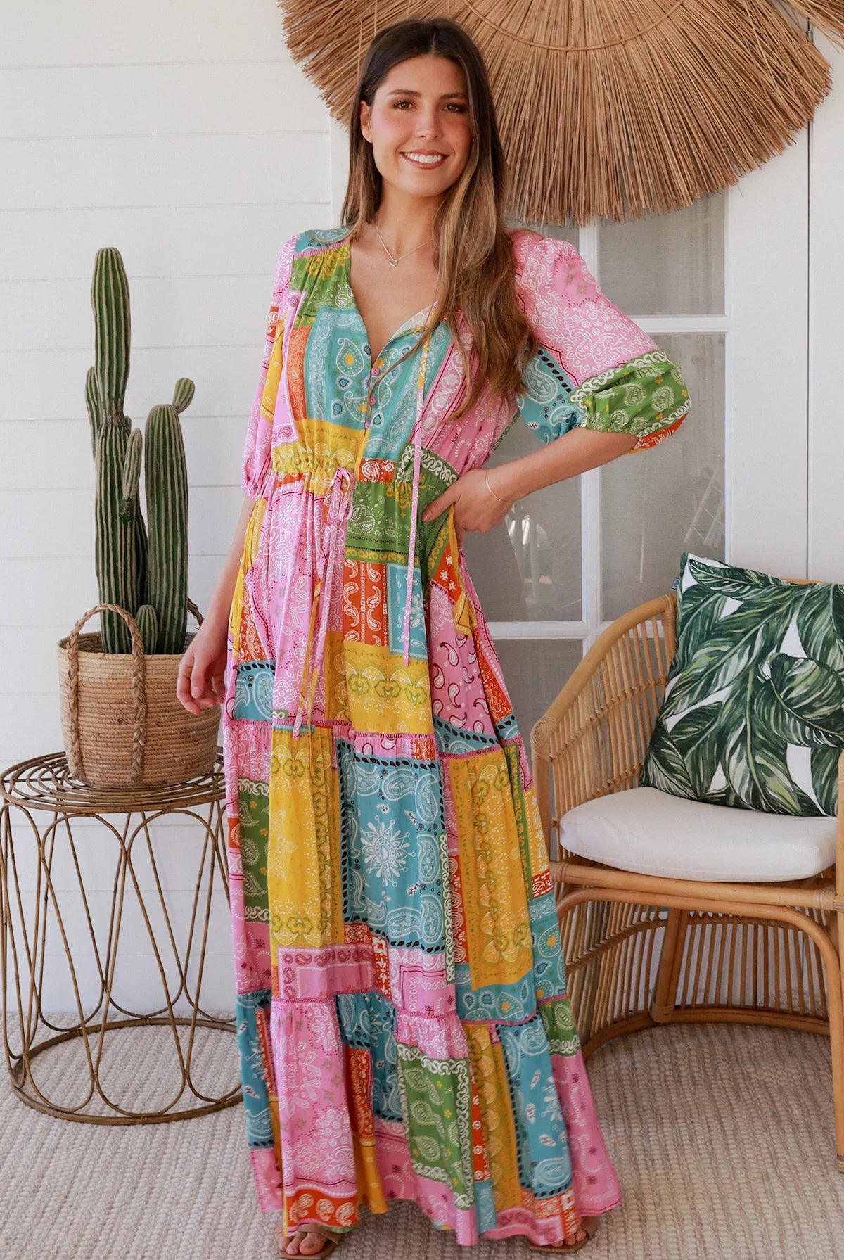 Woman in colourful patchwork paisley boho maxi dress with v-neck button bodice and tiered skirt - Boho Fashion Australia