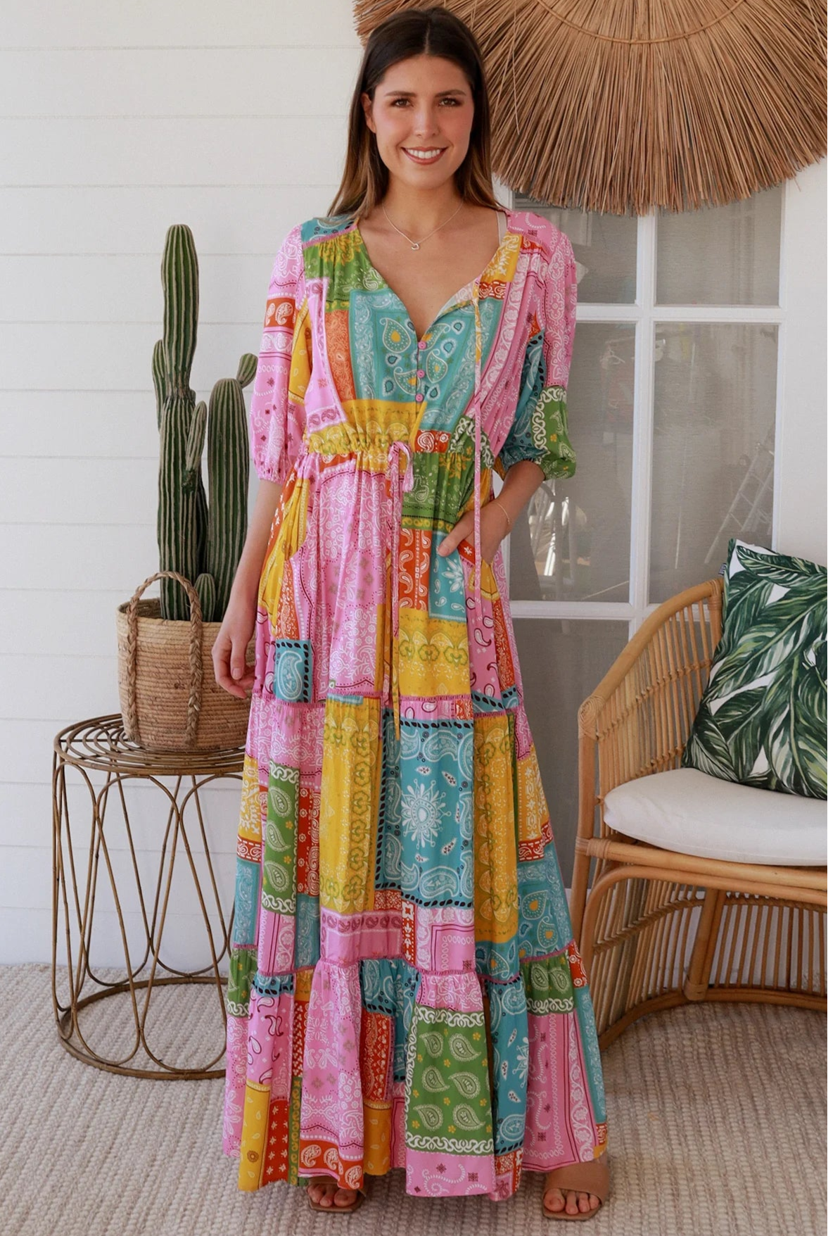 Woman in colourful patchwork paisley boho maxi dress with v-neck button bodice and tiered skirt - Boho Fashion Australia