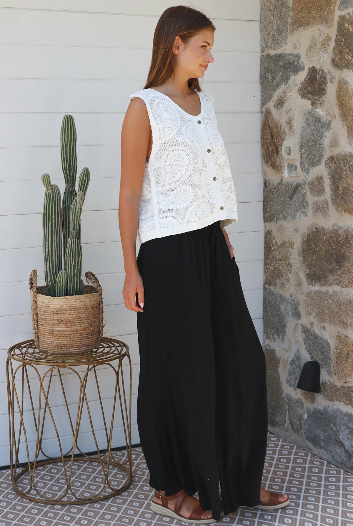 Black wide-leg rayon pants with elastic waist, front tie and side pockets