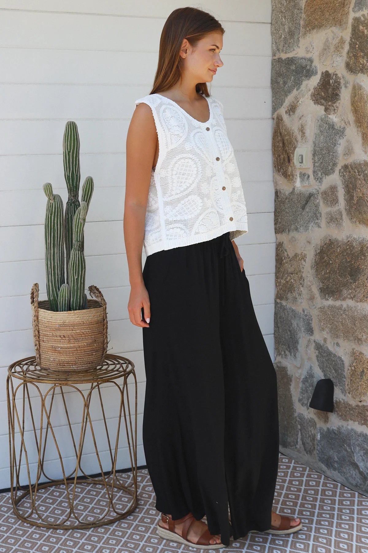 Black wide-leg rayon pants with elastic waist, front tie and side pockets