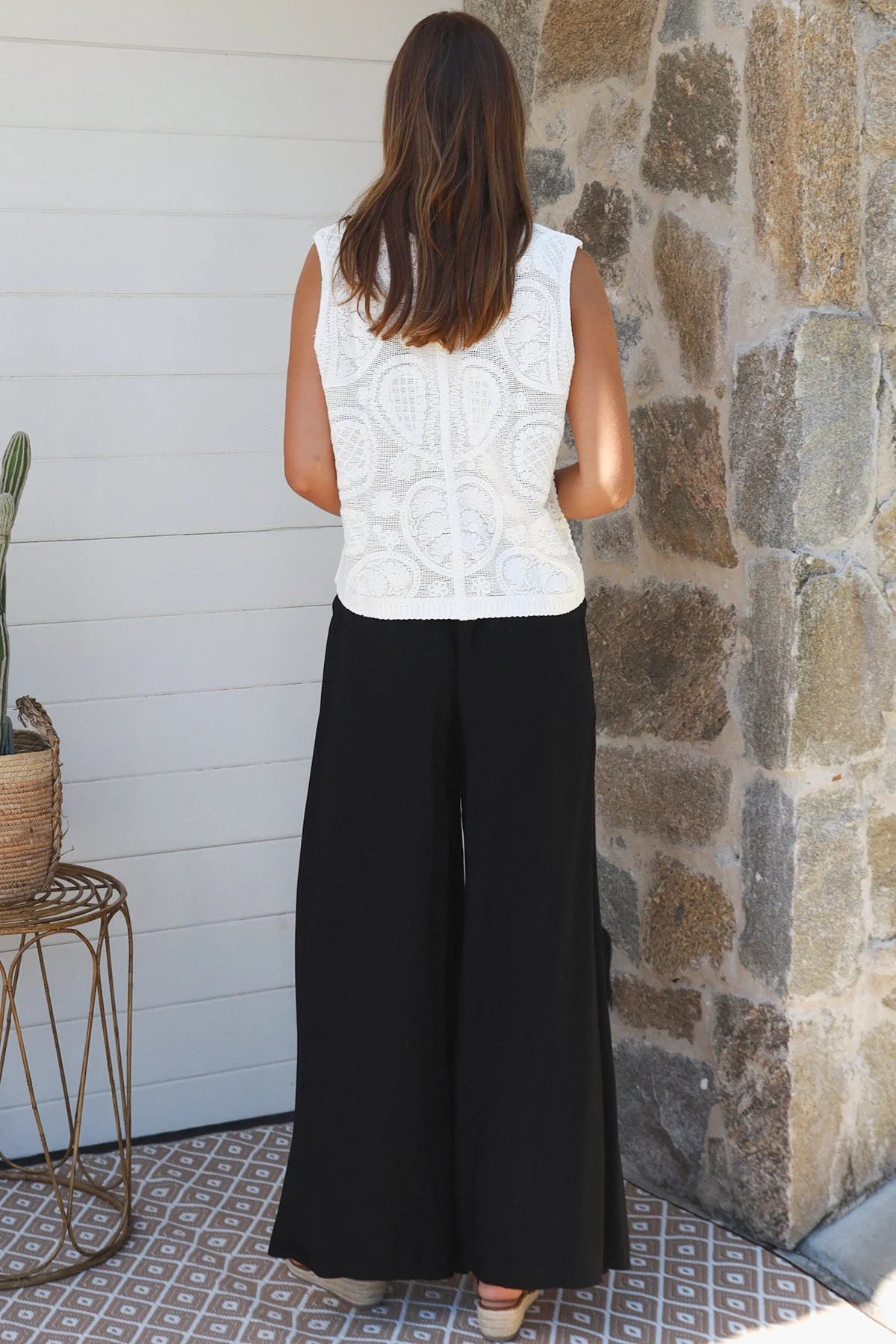 Black wide-leg rayon pants with elastic waist, front tie and side pockets