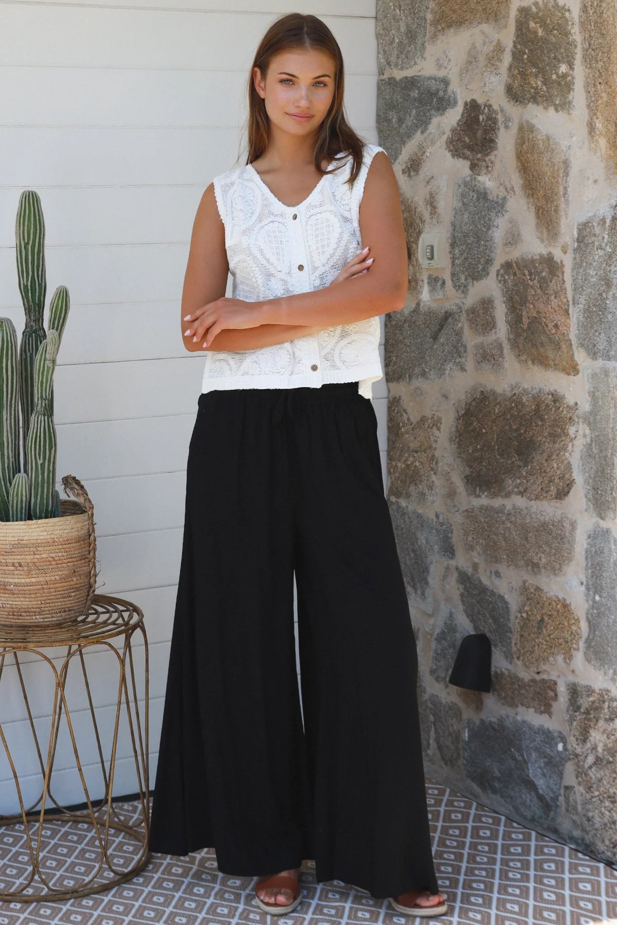 Black wide-leg rayon pants with elastic waist, front tie and side pockets