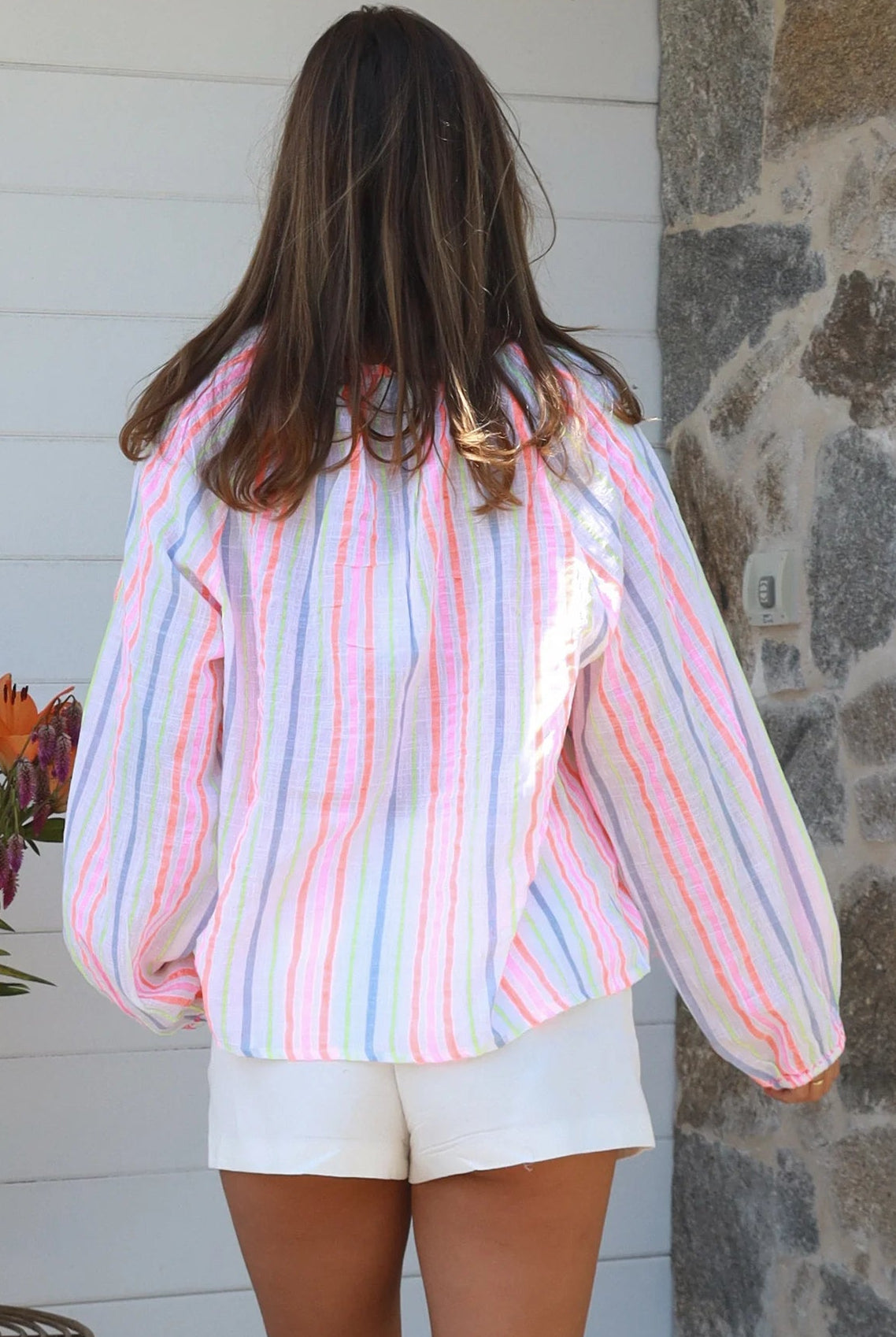 Woman wearing Palm Cove cotton embroidered striped boho tunic top with tassel V neckline and long sleeves