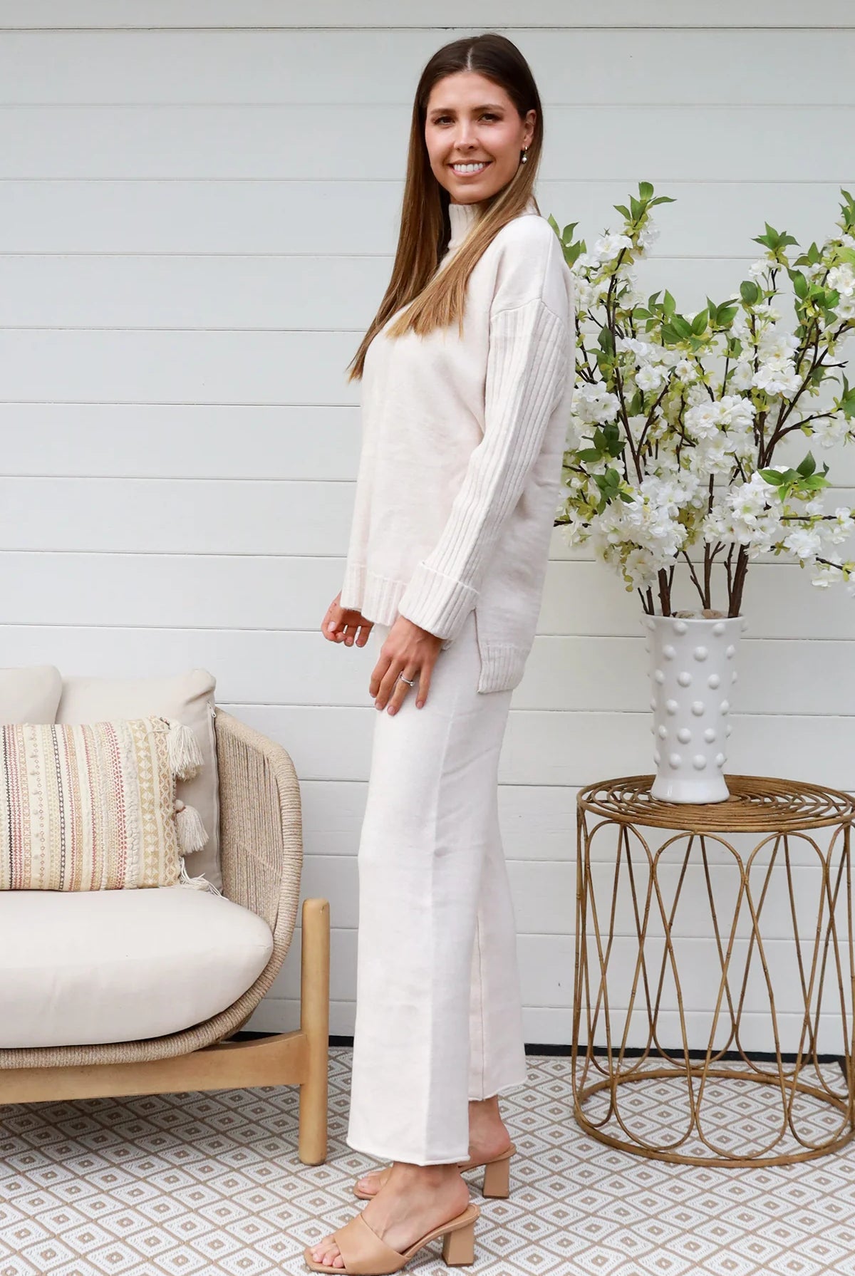 Model wearing cream knit lounge set with high-neck jumper and wide-leg pants - women's loungewear Australia.