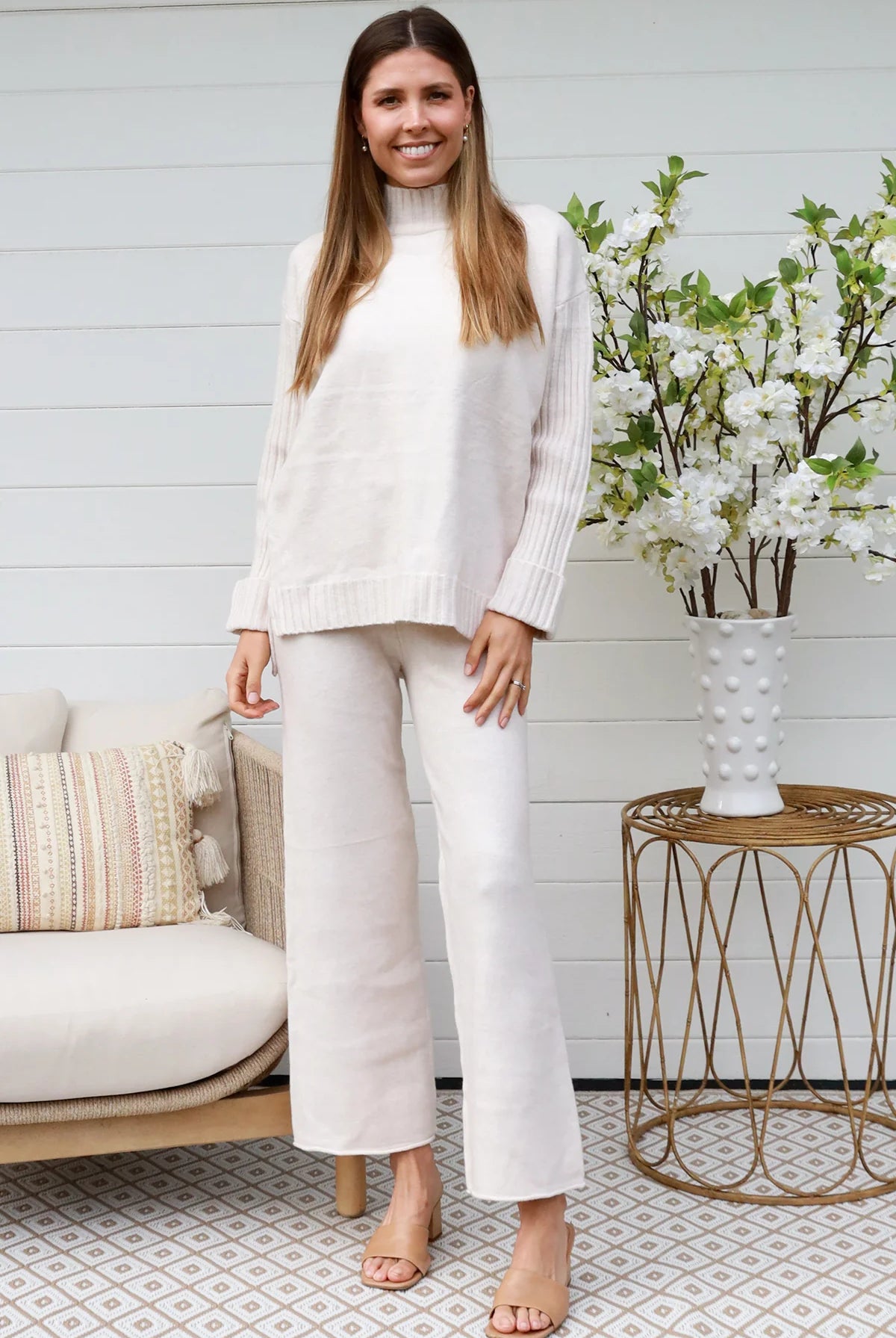 Model wearing cream knit lounge set with high-neck jumper and wide-leg pants - women's loungewear Australia.