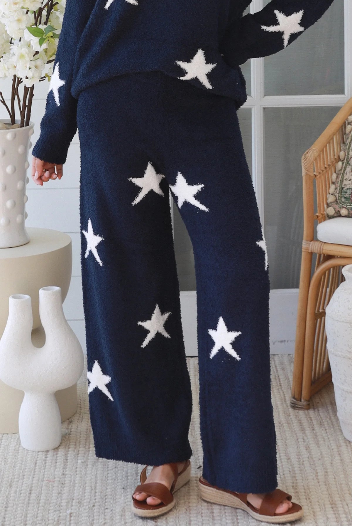 Charlotte The Label Star Soft Brushed Knit Pants in navy featuring a soft brushed knit, closely placed white star design, wide-leg silhouette and elastic waistband.