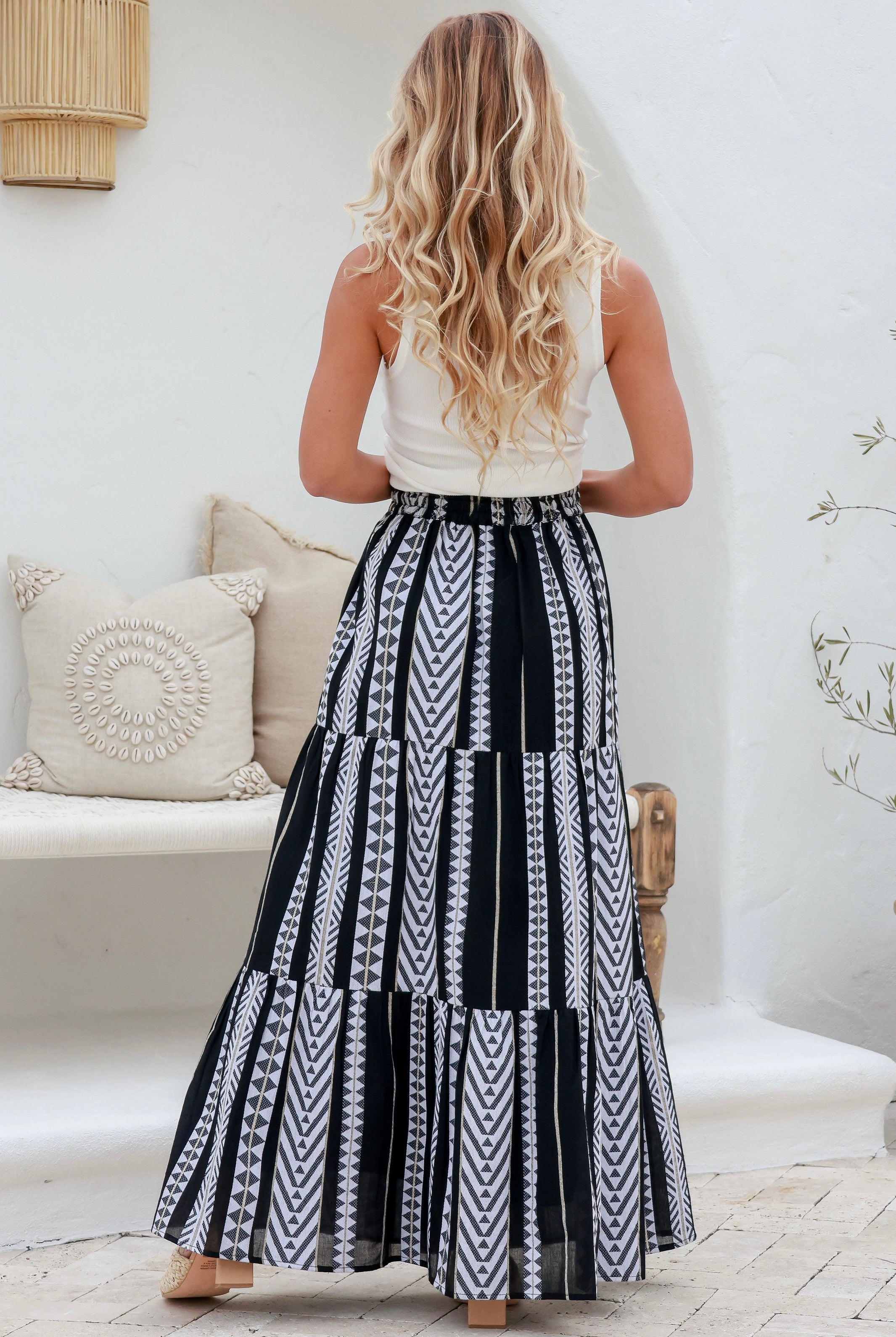 women wearing the Lunar Cotton Boho Maxi Skirt - full-length black and white boho skirt with geometric print, tiered silhouette, and cotton fabric.