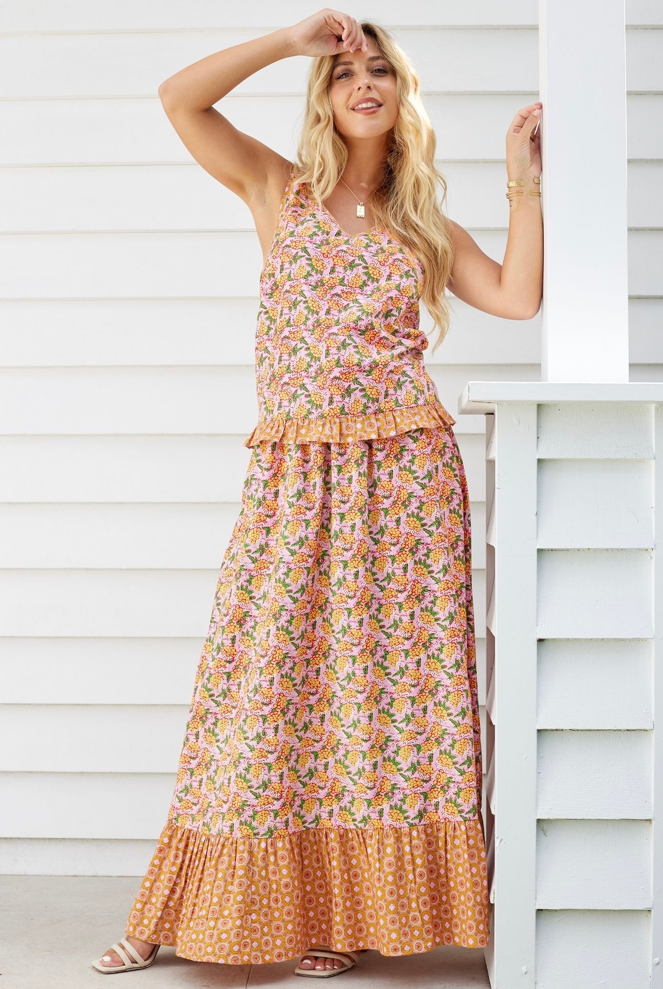 Model wearing boho floral cami top and maxi skirt set in orange and pink