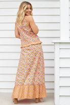 Model wearing boho floral cami top and maxi skirt set in orange and pink