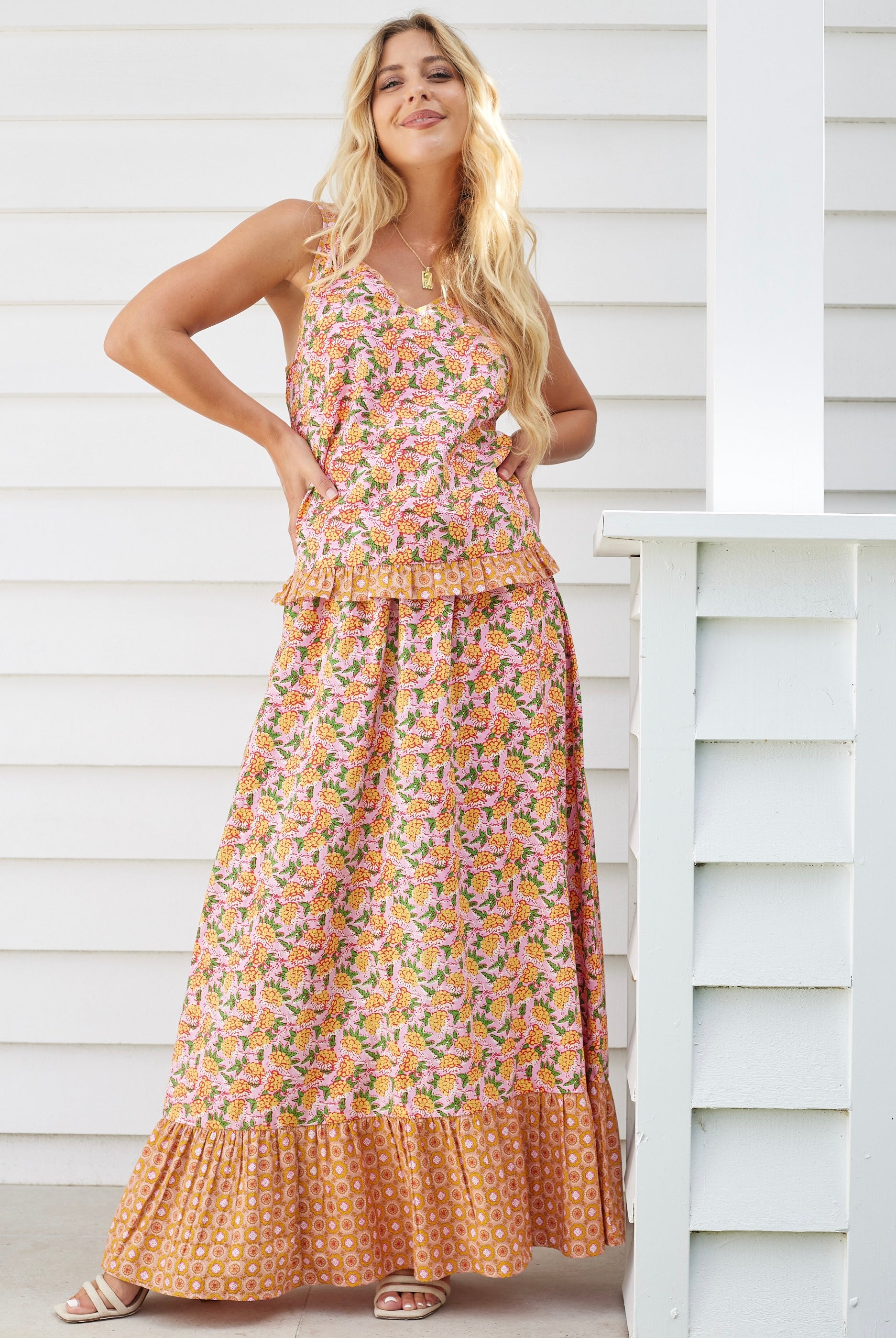 Model wearing boho floral cami top and maxi skirt set in orange and pink