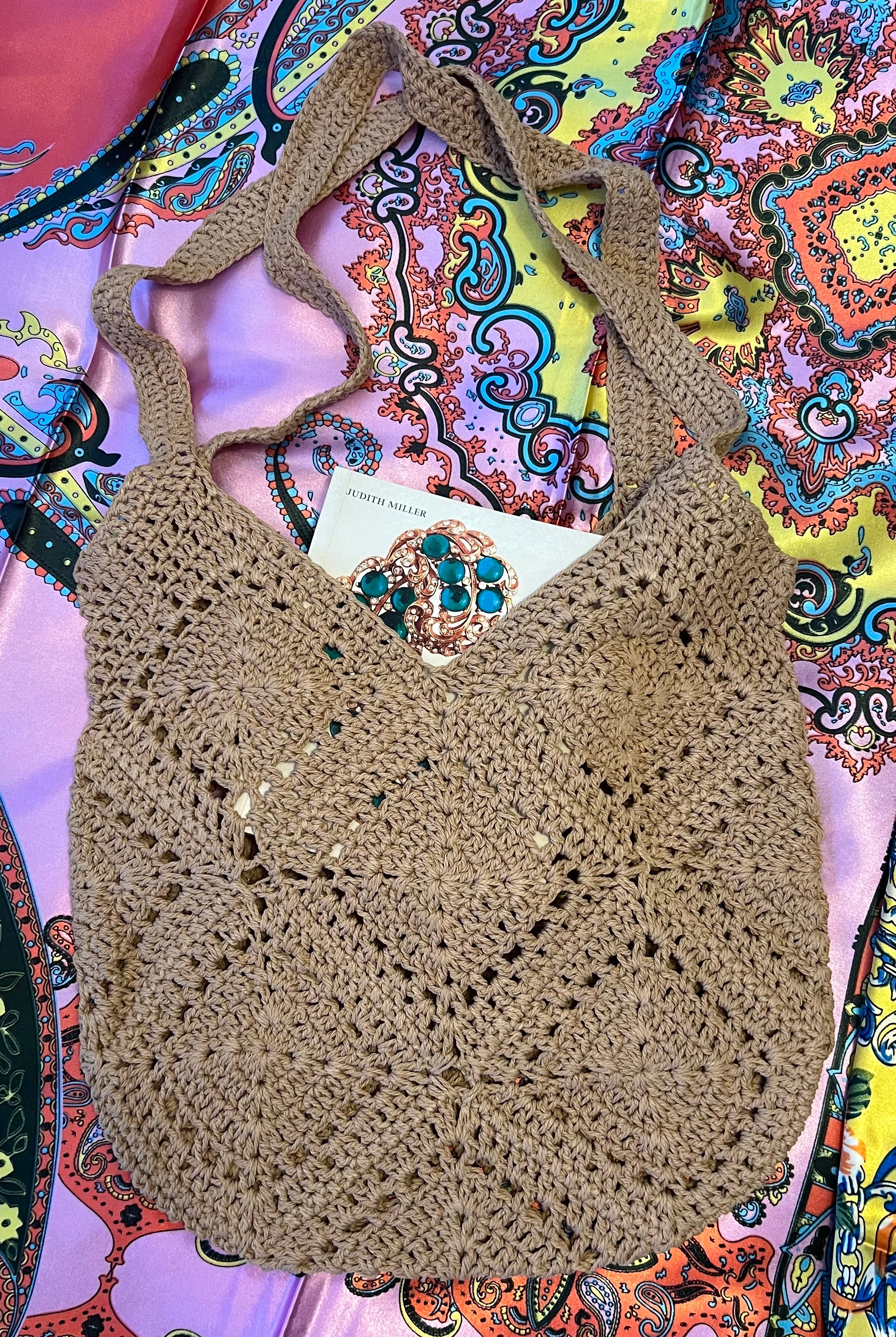 Tan crochet shoulder bag laid flat on a vibrant boho scarf background - artisan-style boho accessory Australia.