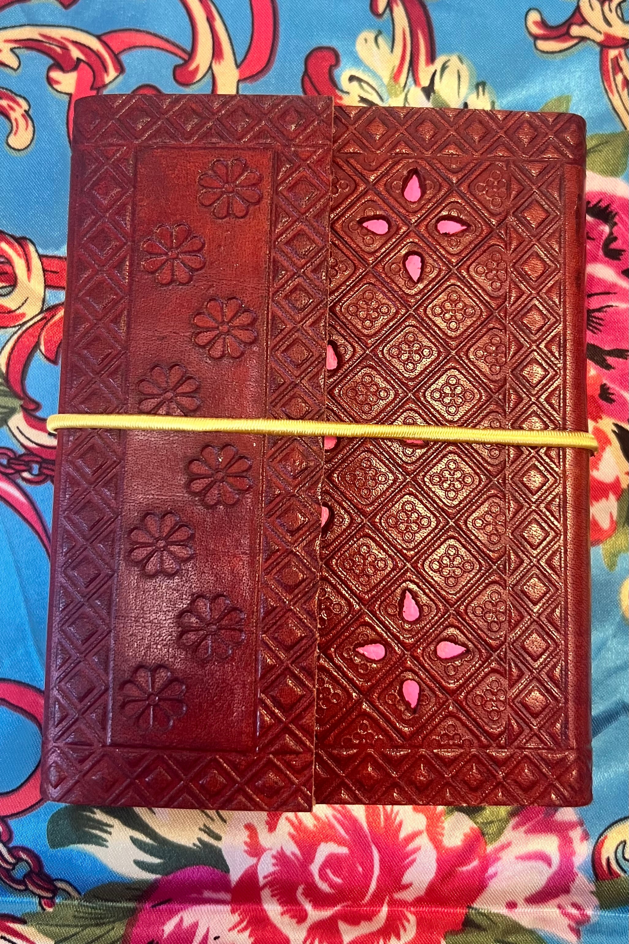 Golden-brown hand-tooled leather B5 journal with embossed curved pattern and blank recycled pages - boho artisan notebook