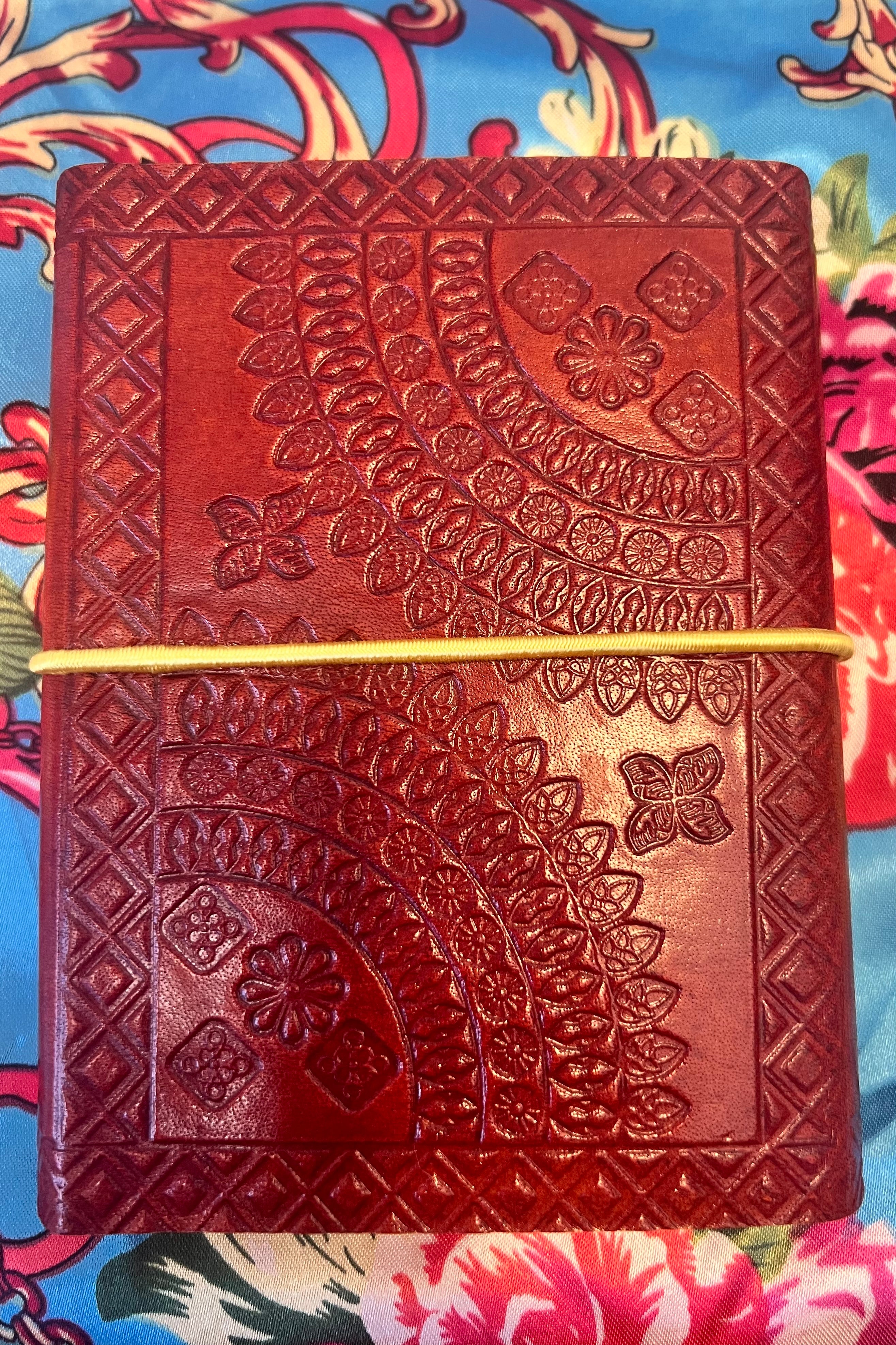 Golden-brown hand-tooled leather B5 journal with embossed curved pattern and blank recycled pages - boho artisan notebook