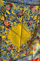 Yellow satin scarf with blue baroque scrolls and red floral print draped in sunlight - boho satin scarves Australia.